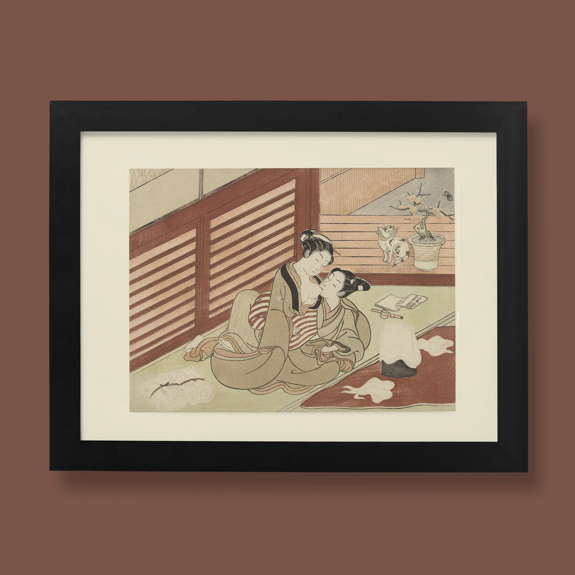 "Two Lovers (An Intimate Scene)" by Suzuki Harunobu, a Japanese Edo-period shunga woodblock print depicting two women embracing intimately in a traditional tatami room. The soft, muted colours highlight their kimonos and affectionate expressions, with a serene domestic background featuring a cat, bonsai tree, and writing tools.