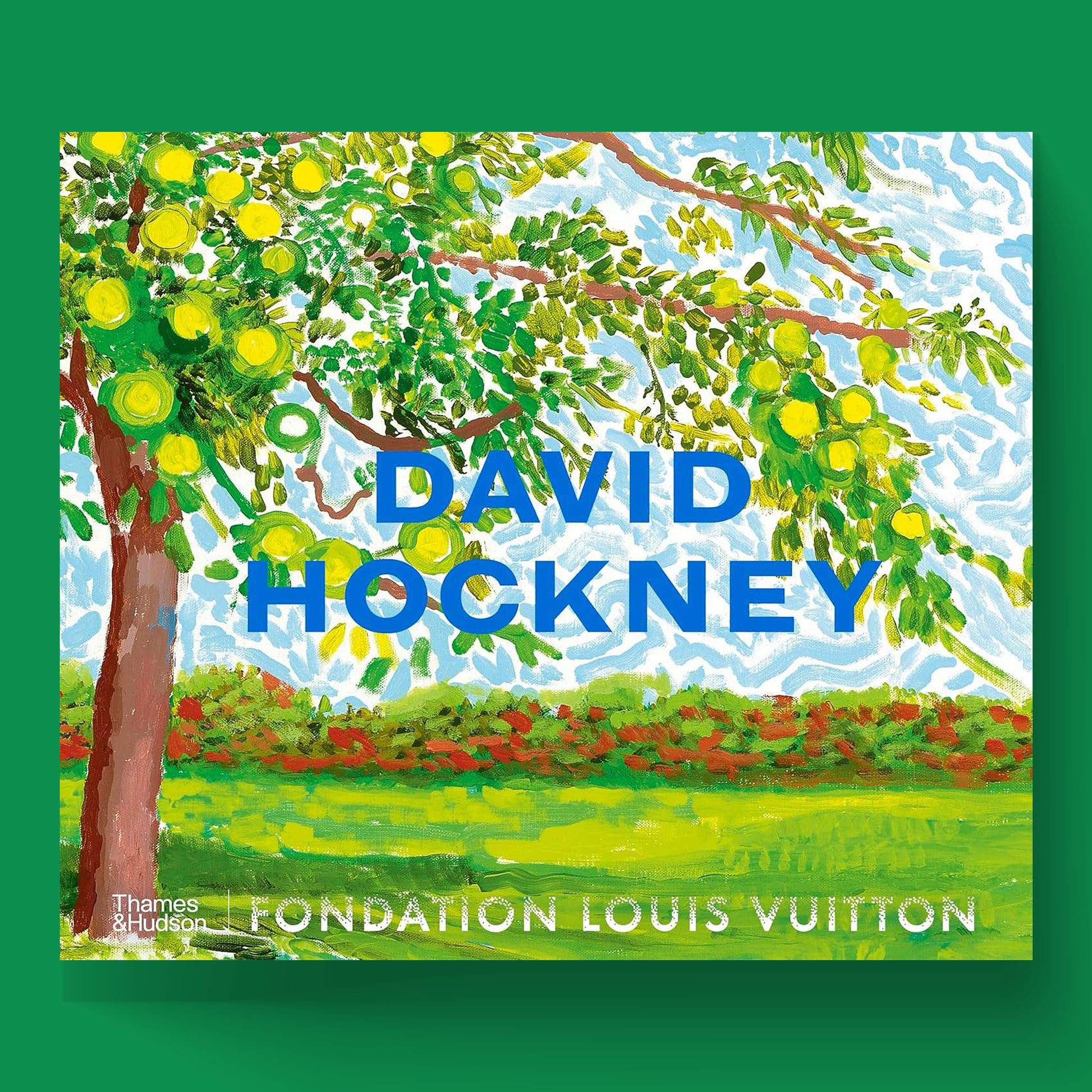 The front cover of the David Hockney coffee table book, published by Thames & Hudson in association with Fondation Louis Vuitton. The cover features a vivid landscape painting by the artist with "David Hockney" written prominently in blue.