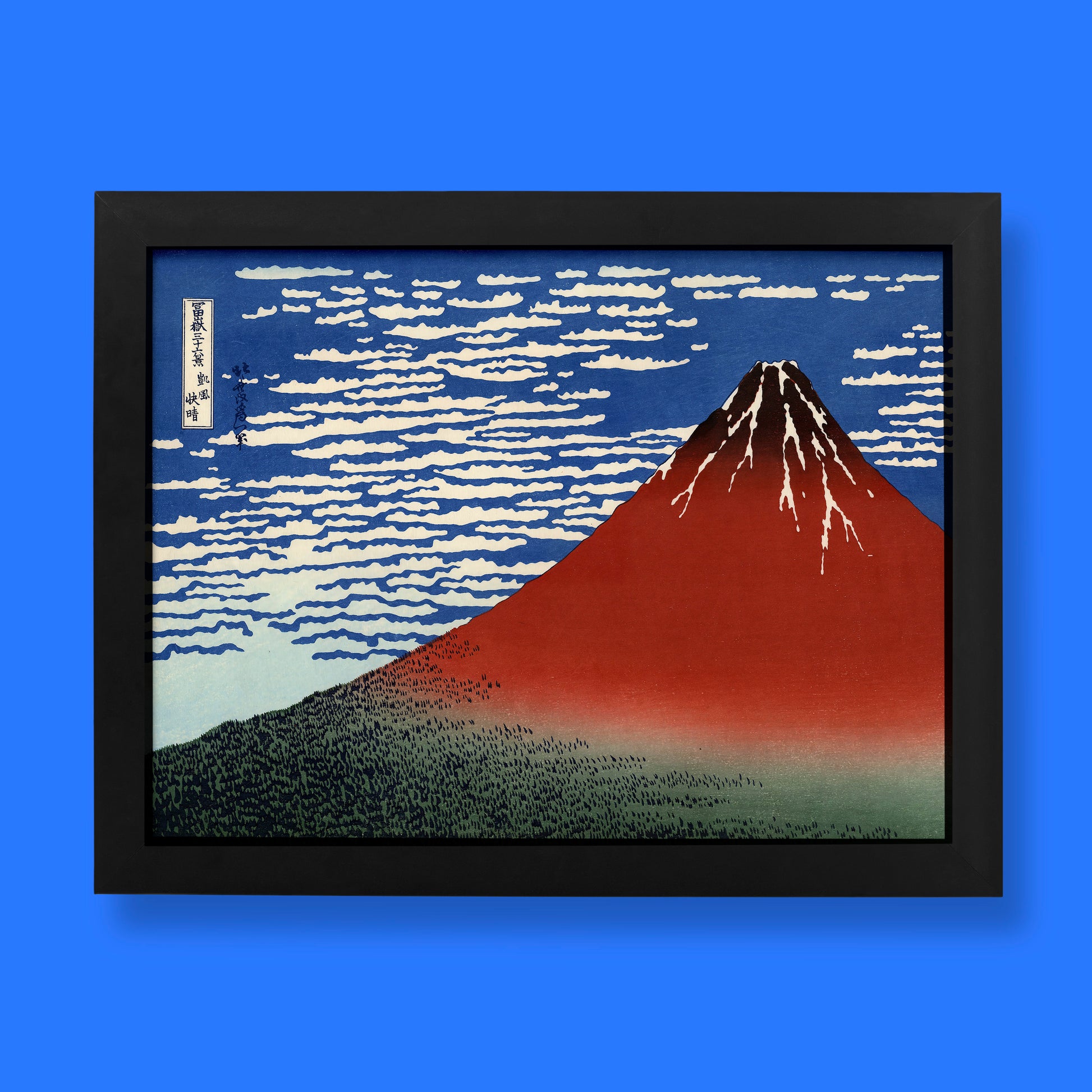 Framed artwork of Mount Fuji with a blue sky on a blue background
