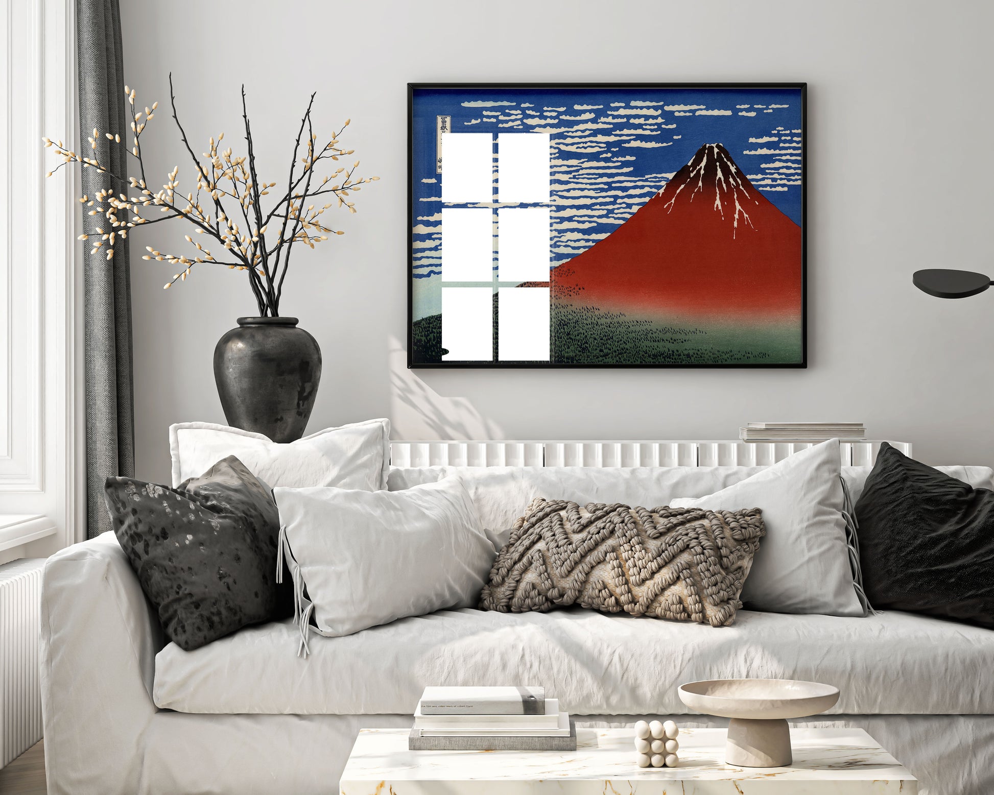 Living room with a white sofa, decorative pillows, and a framed artwork of a mountain.