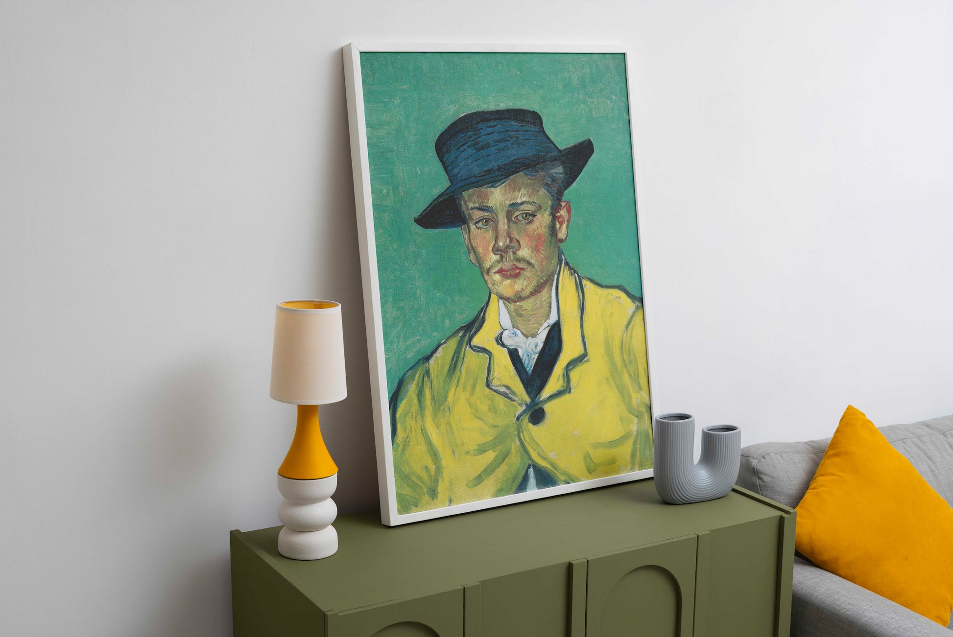 Large framed art print of Vincent van Gogh's Portrait of Armand Roulin with a white frame, displayed as stylish wall art in a modern living room setting.