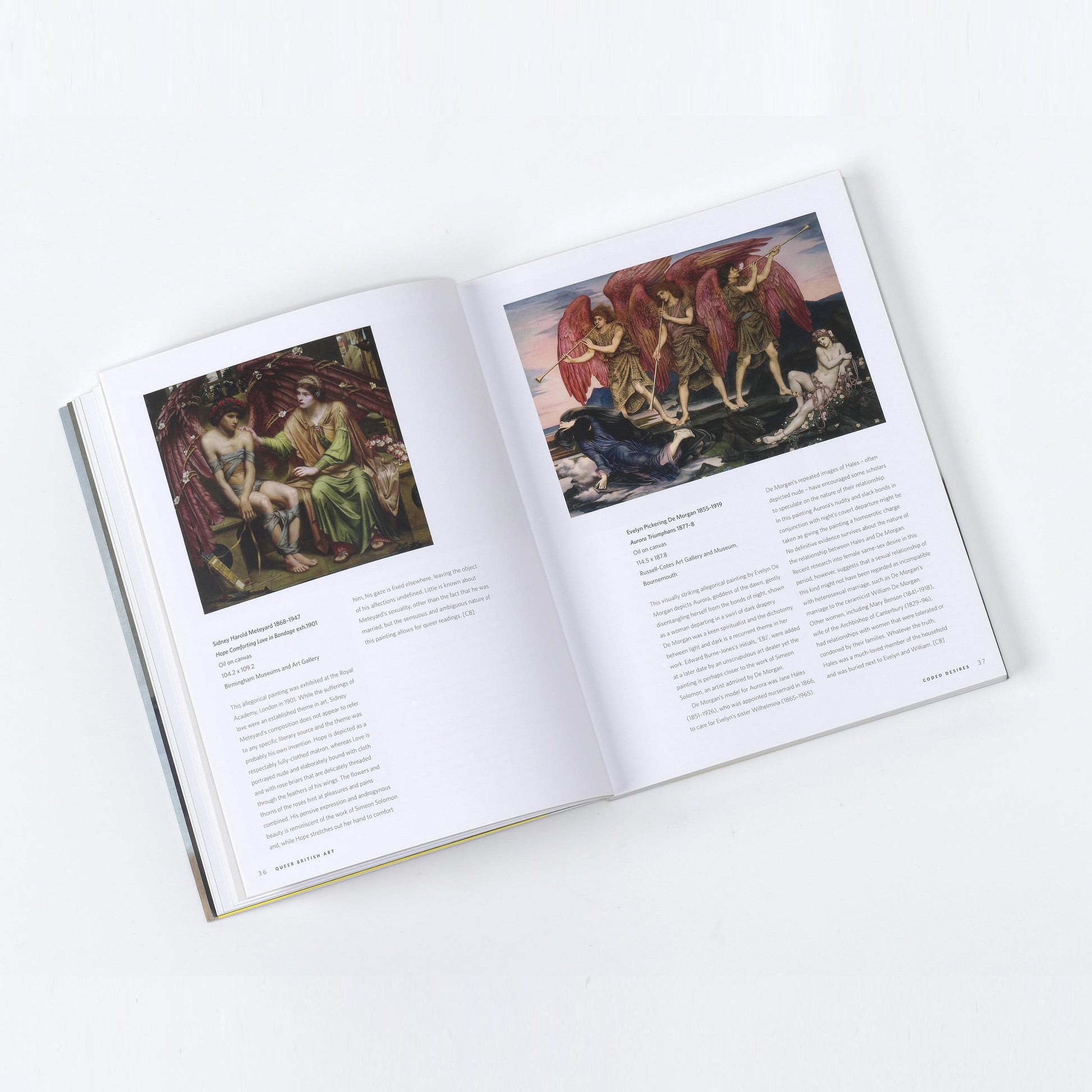 A detailed view of the Queer British Art publication, featuring the painting "The Love of the Angel" by Sir Edward Coley Burne-Jones.