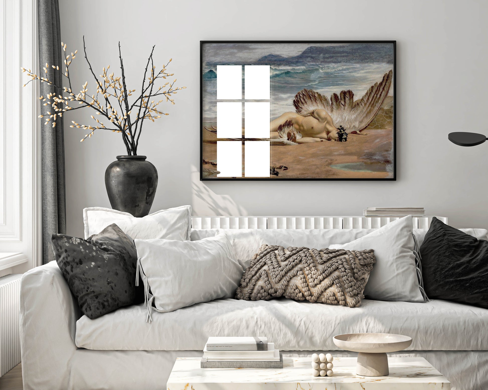A beautiful framed wall art piece of Alexandre Cabanel's 'The Death of Icarus', shown hanging in a stylish modern living room. The frame is a clean, simple black wood that complements the classical art print.