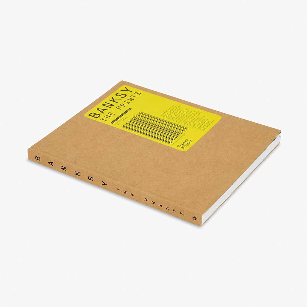 Banksy The Prints coffee table book front cover with brown kraft paper and bright yellow label featuring title barcode design and Thames and Hudson publisher logo