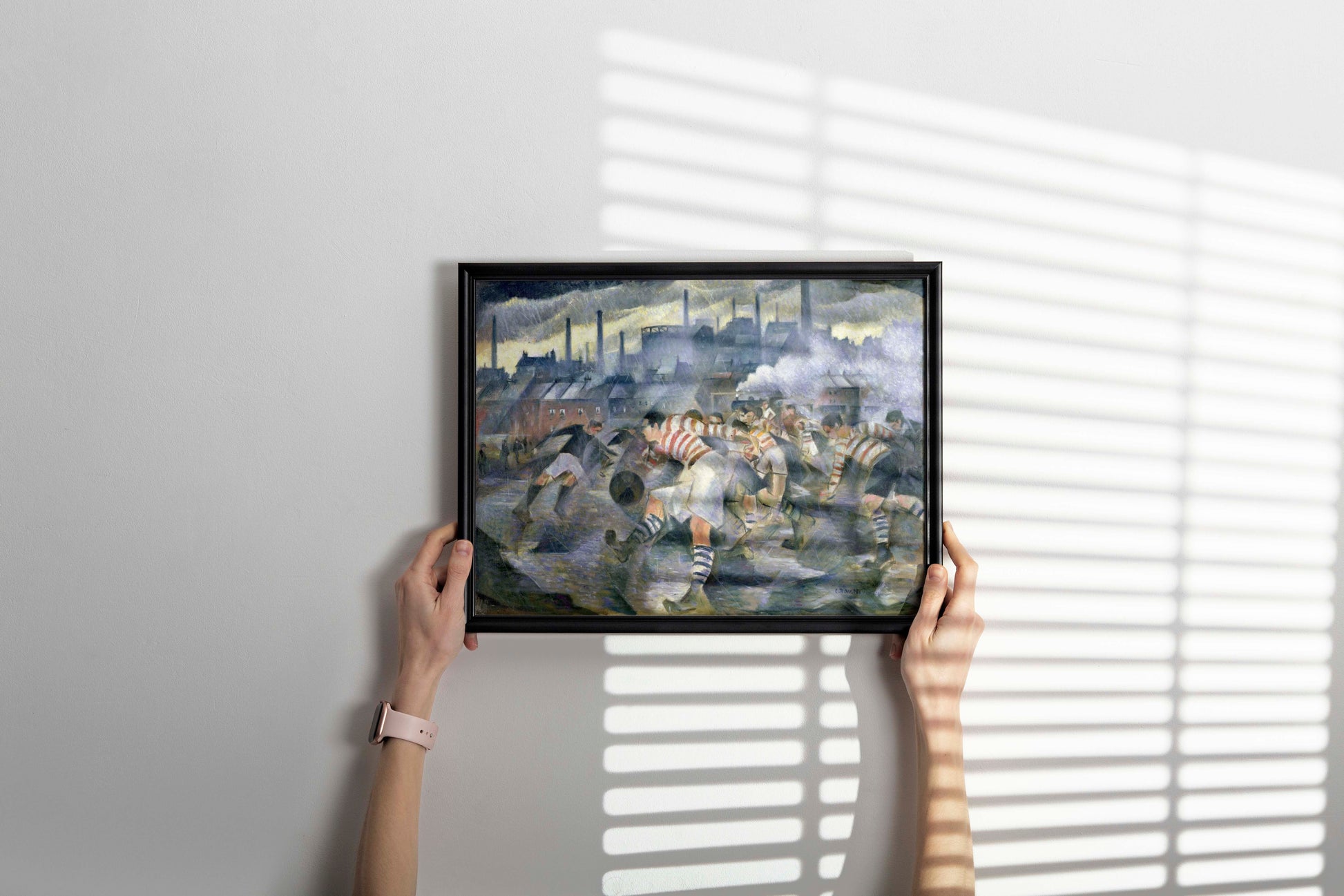 Framed wall art featuring Nevinson's 1930 football players painting in contemporary home interior, demonstrating how vintage British modernist art enhances modern room decor