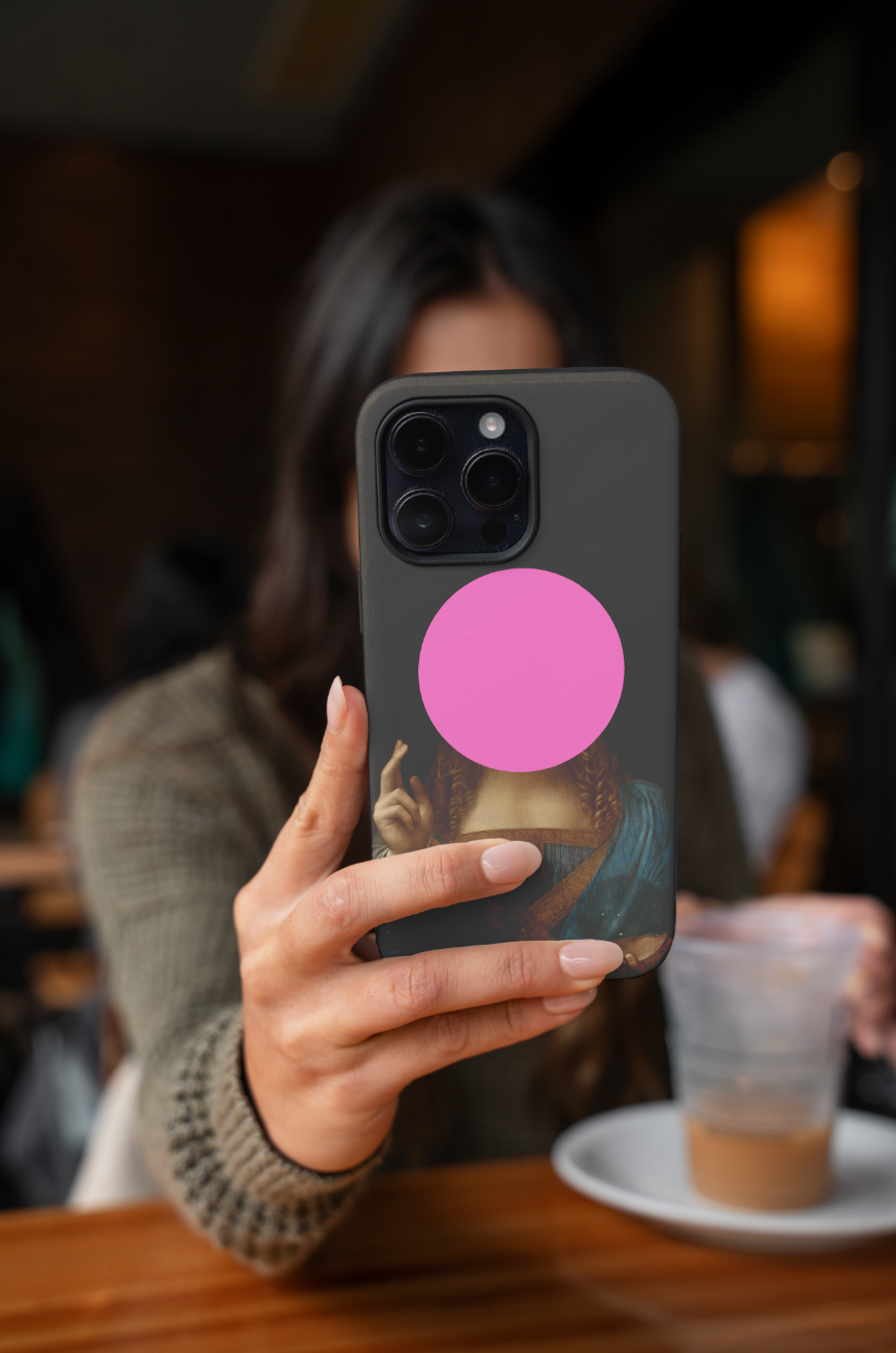Artistic phone case with a wraparound print of Leonardo da Vinci's Salvator Mundi and a vibrant pink circle obscuring the face, a unique and modern take on a historical masterpiece.