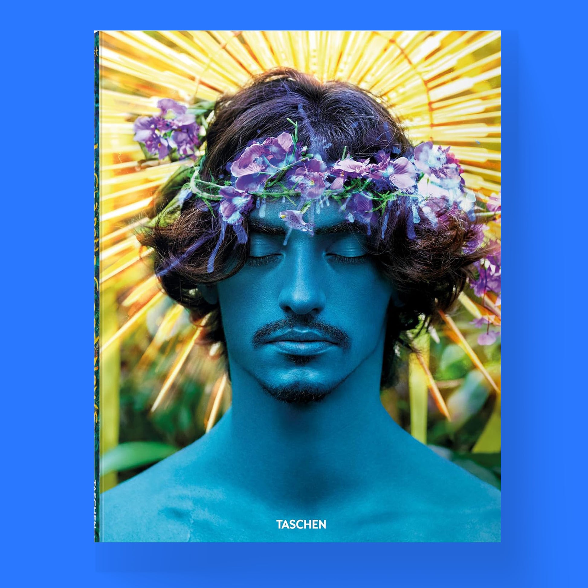 The cover of the David LaChapelle Good News book, showing a portrait of a person with blue skin and a floral crown against a yellow background.