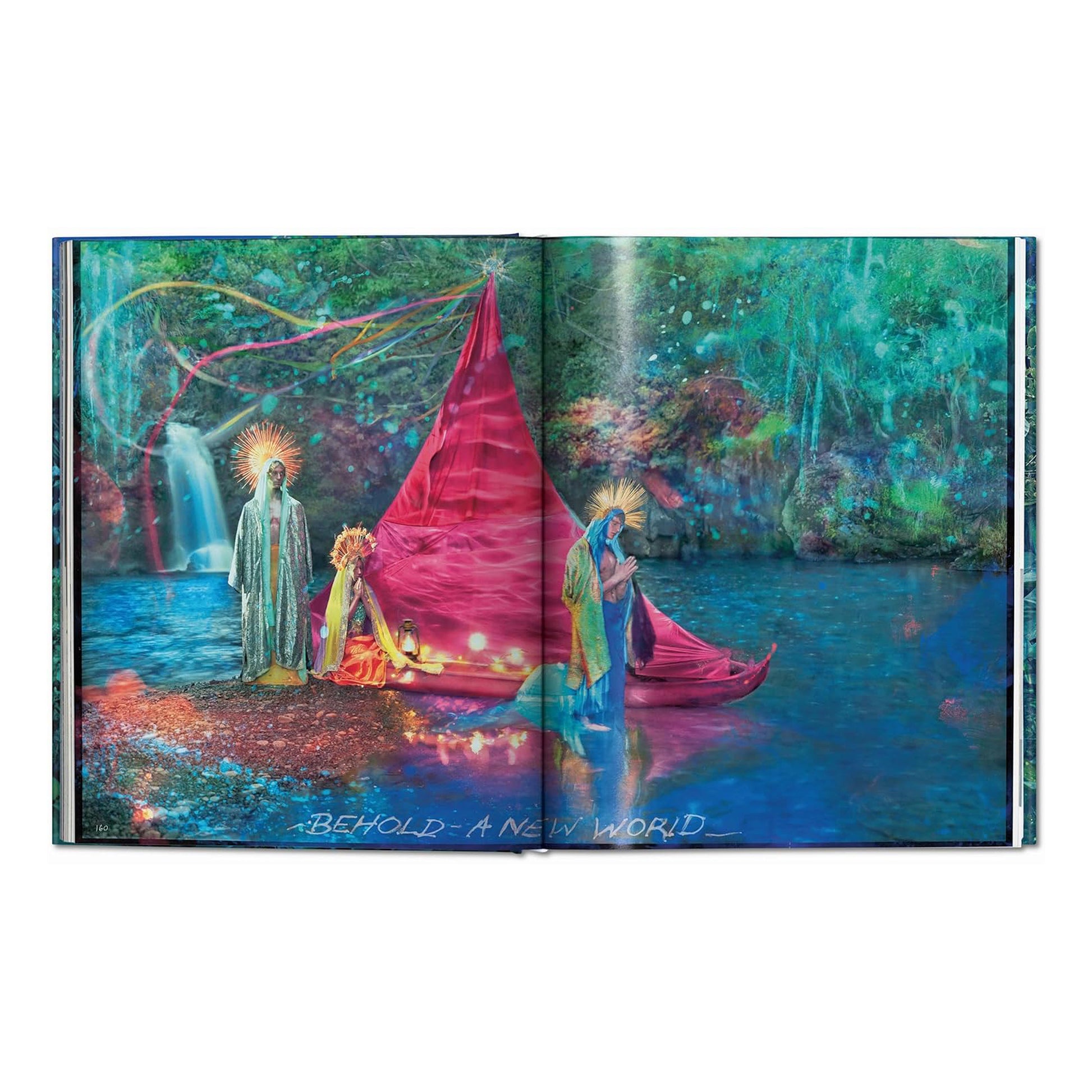 A double-page spread from the David LaChapelle Taschen luxury art book with a fantasy scene of two figures in ornate robes standing by a river with a red tent-like structure and waterfall in the background.