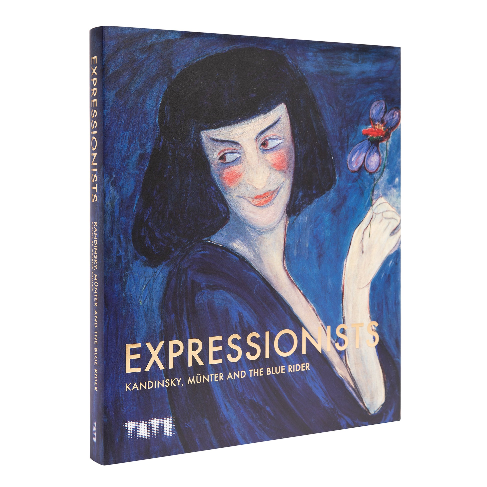 An angled view of the Tate's 'Expressionists' book, showing the gold lettering on the spine and the full cover art, highlighting its luxury hardback quality.