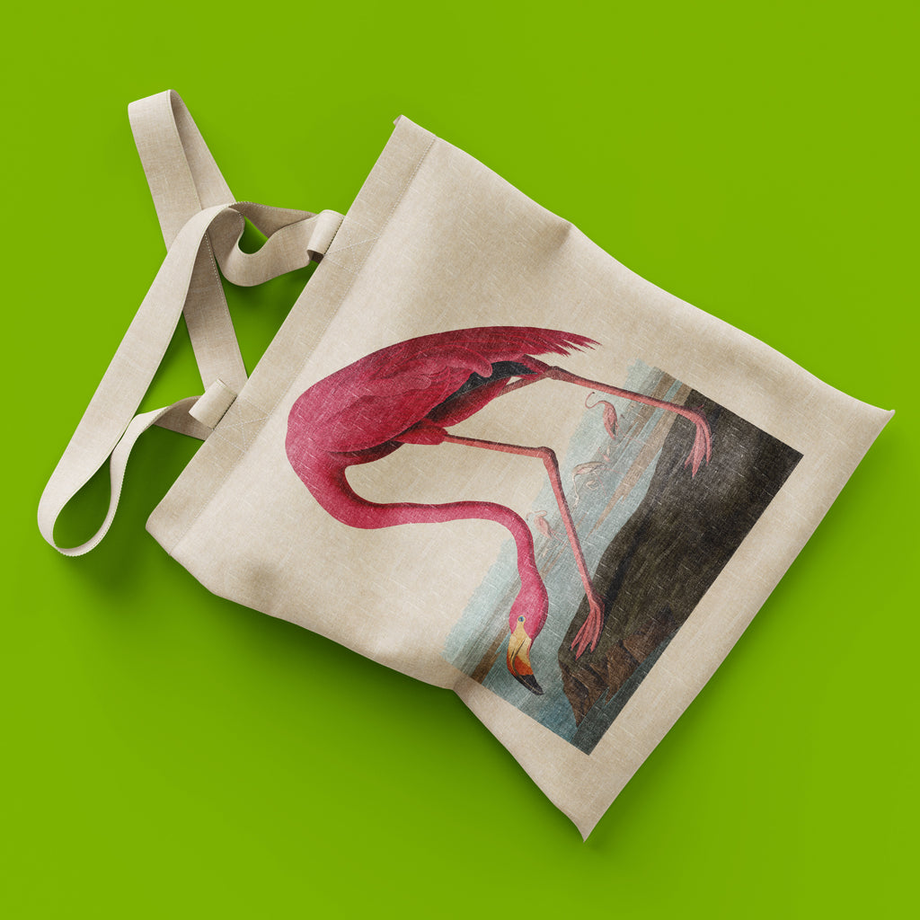Tote bag with a pink flamingo design on a green background
