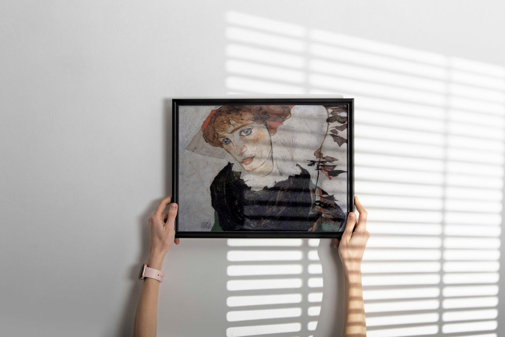 A framed giclée print of Egon Schiele's "Portrait of Wally Neuzil" hanging on a wall, showcasing a sophisticated piece of expressionist art.