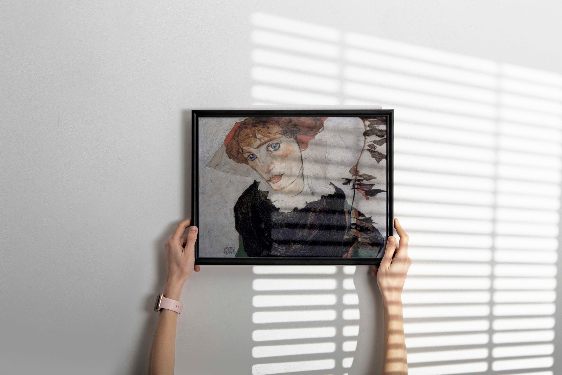 A framed giclée print of Egon Schiele's "Portrait of Wally Neuzil" hanging on a wall, showcasing a sophisticated piece of expressionist art.
