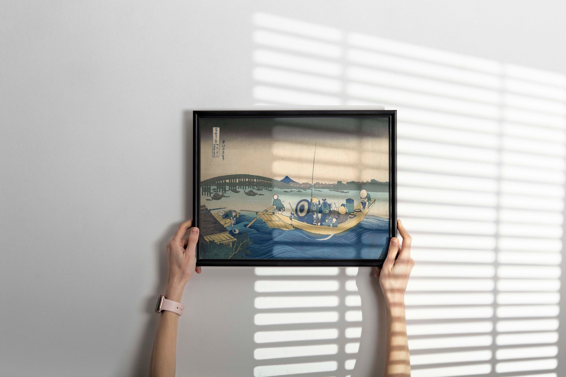 Framed Katsushika Hokusai Mount Fuji ferry scene art print displayed as sophisticated wall decor in contemporary home setting