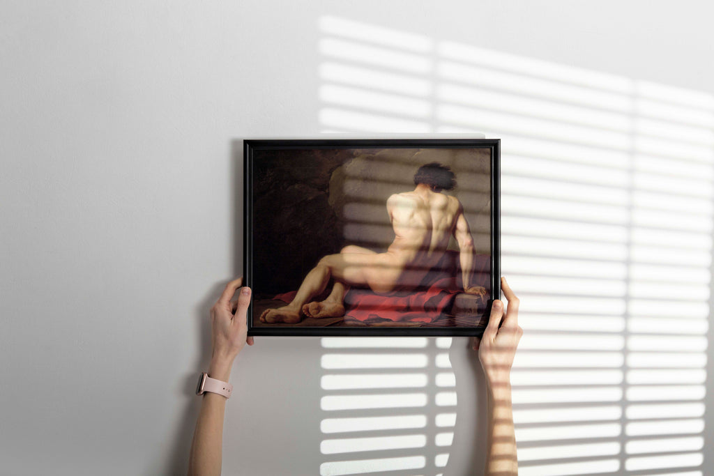 Framed artwork of a nude Patroclus on a white wall with blinds casting shadows.
