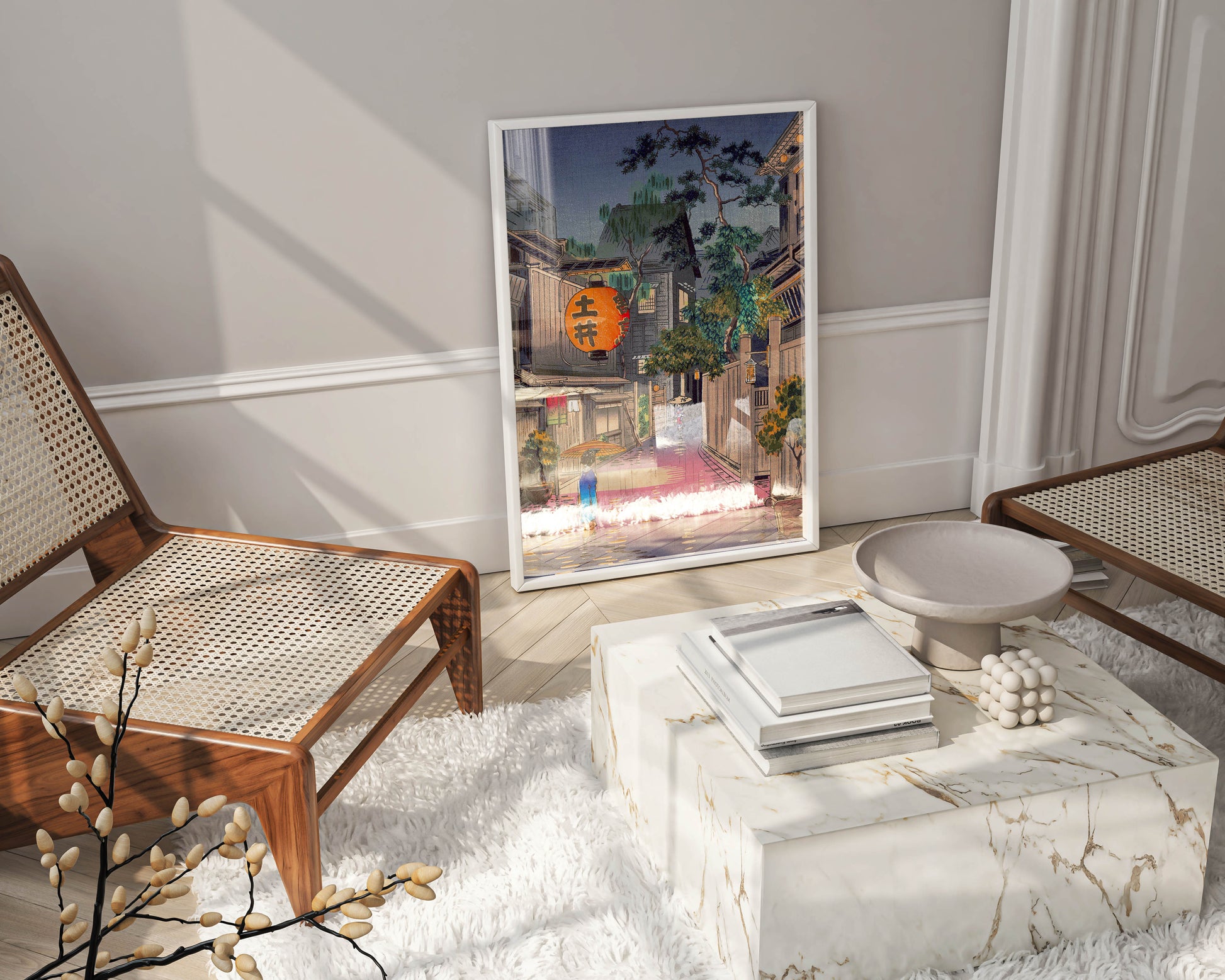 A large framed Tsuchiya Koitsu Japanese art print leaning against a wall on a light wood floor, positioned next to a modern marble coffee table and woven chairs in a stylish living space, highlighting its use as contemporary home decor.