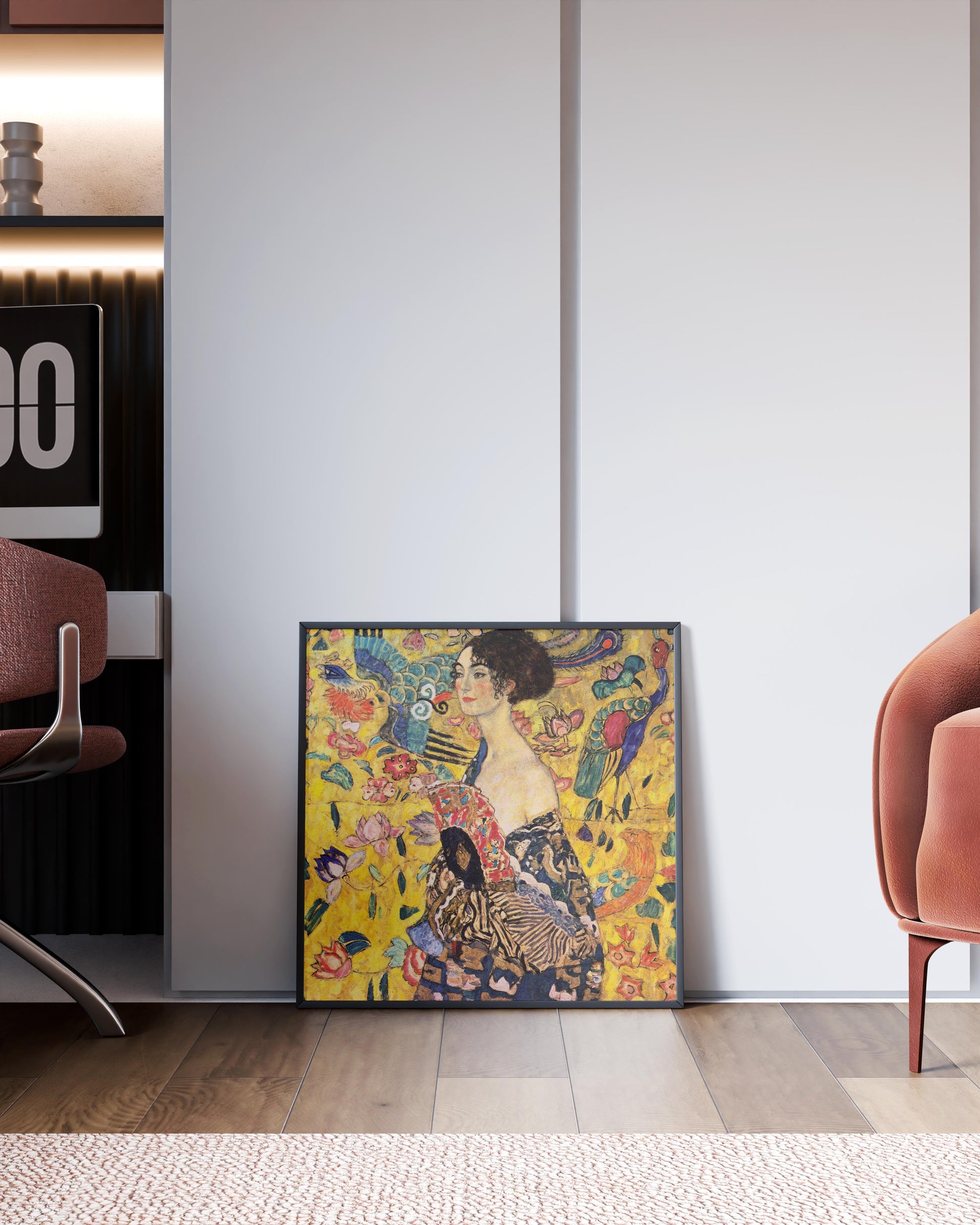 A framed Gustav Klimt "Lady with Fan" giclée fine art print leaning against a white wall in a modern living room interior, showcasing the artwork as stylish wall decor.