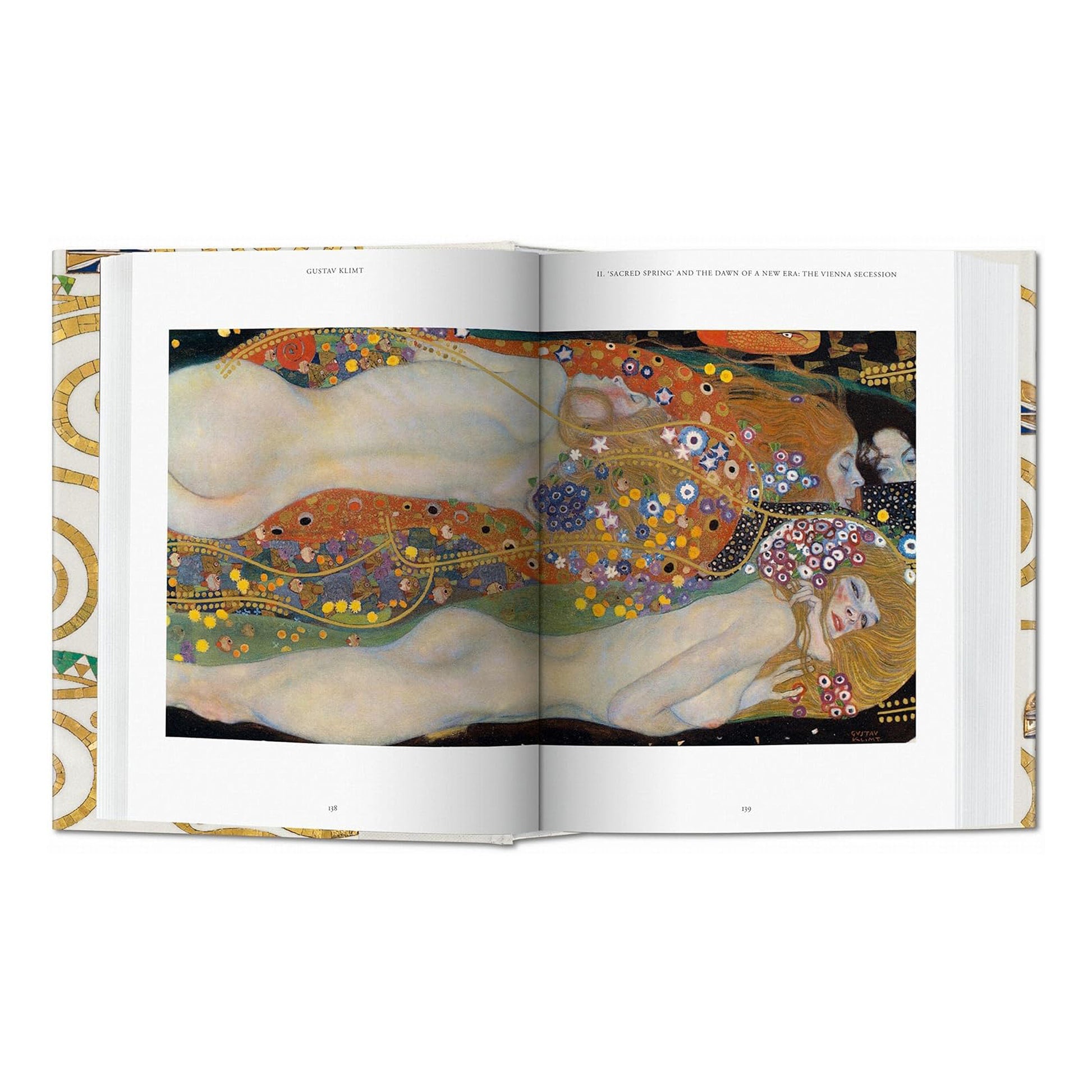 A two-page spread from the luxury Gustav Klimt coffee table book, featuring a detailed painting of reclining nudes with vibrant patterns and gold accents. High-quality reproductions of fine art.