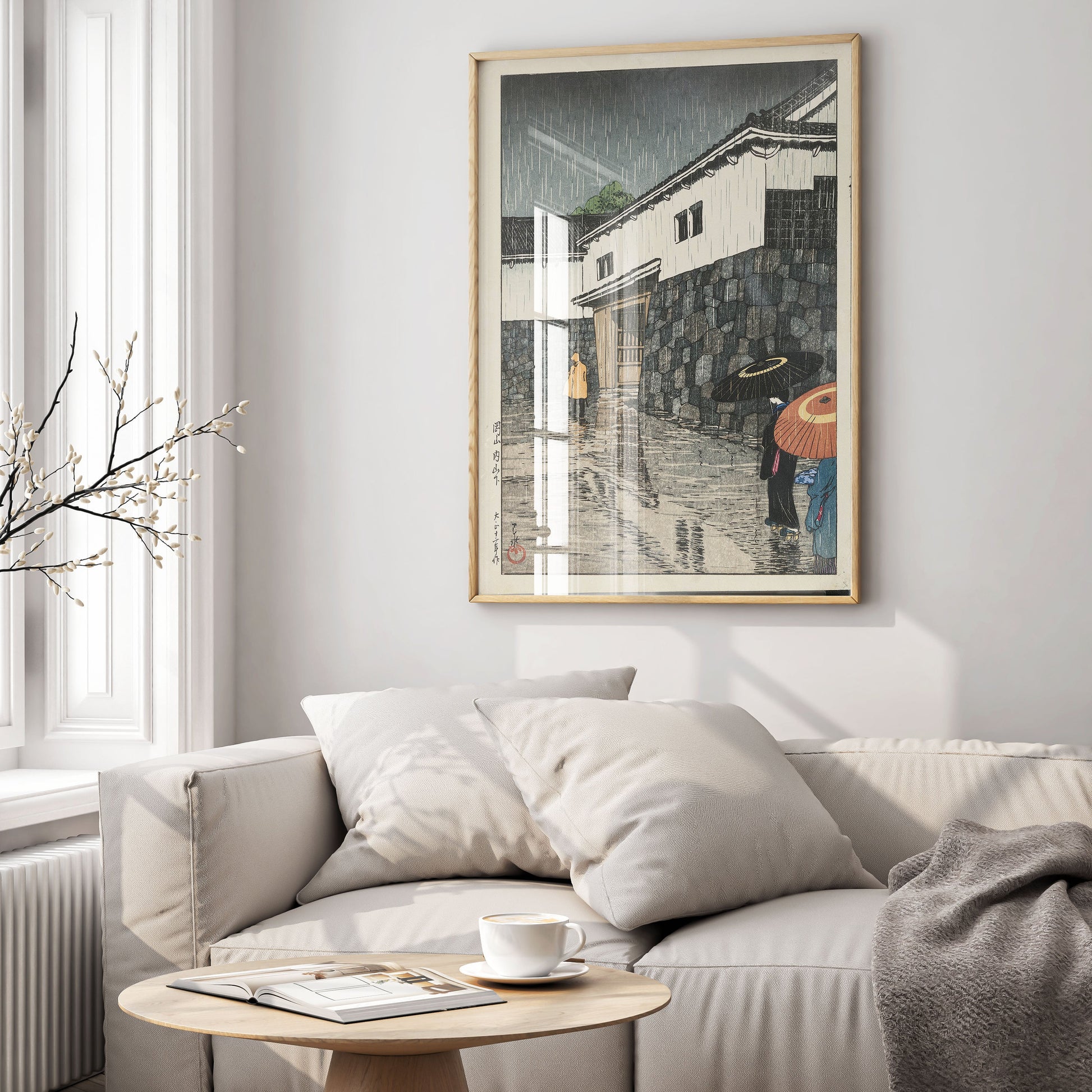 Framed Hasui Kawase Uchisange Okayama wall art featuring Japanese woodblock print of rainy street scene with traditional umbrellas displayed in modern interior setting