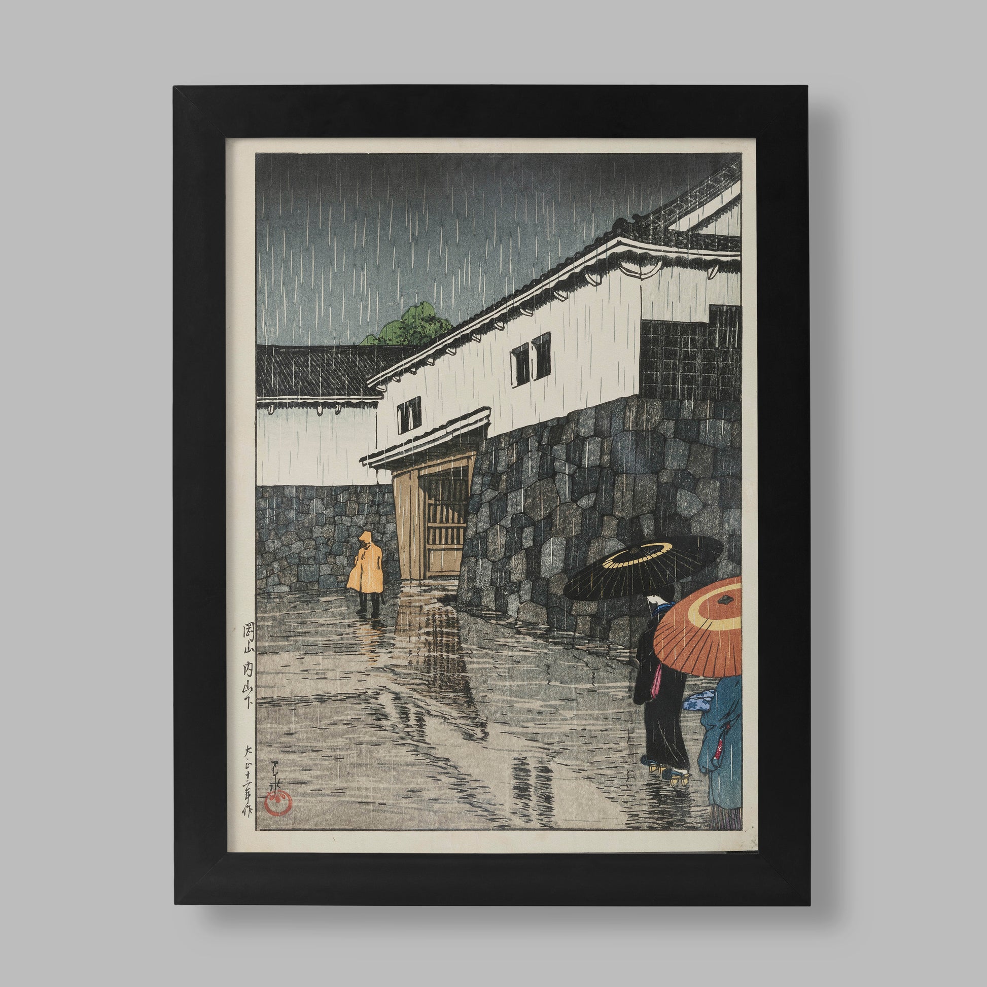 Hasui Kawase Uchisange Okayama Japanese woodblock print featuring figures with traditional umbrellas walking through a rainy street near castle walls