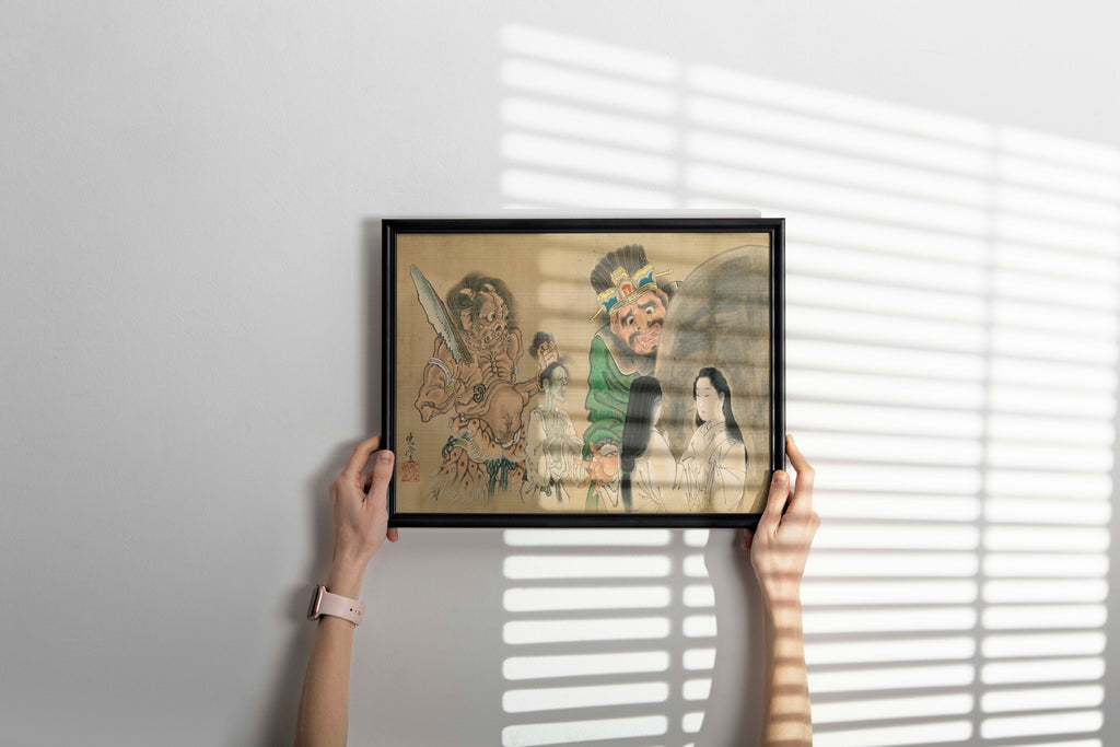 Framed artwork of a traditional Japanese art print with people, held against a white wall with horizontal blinds.