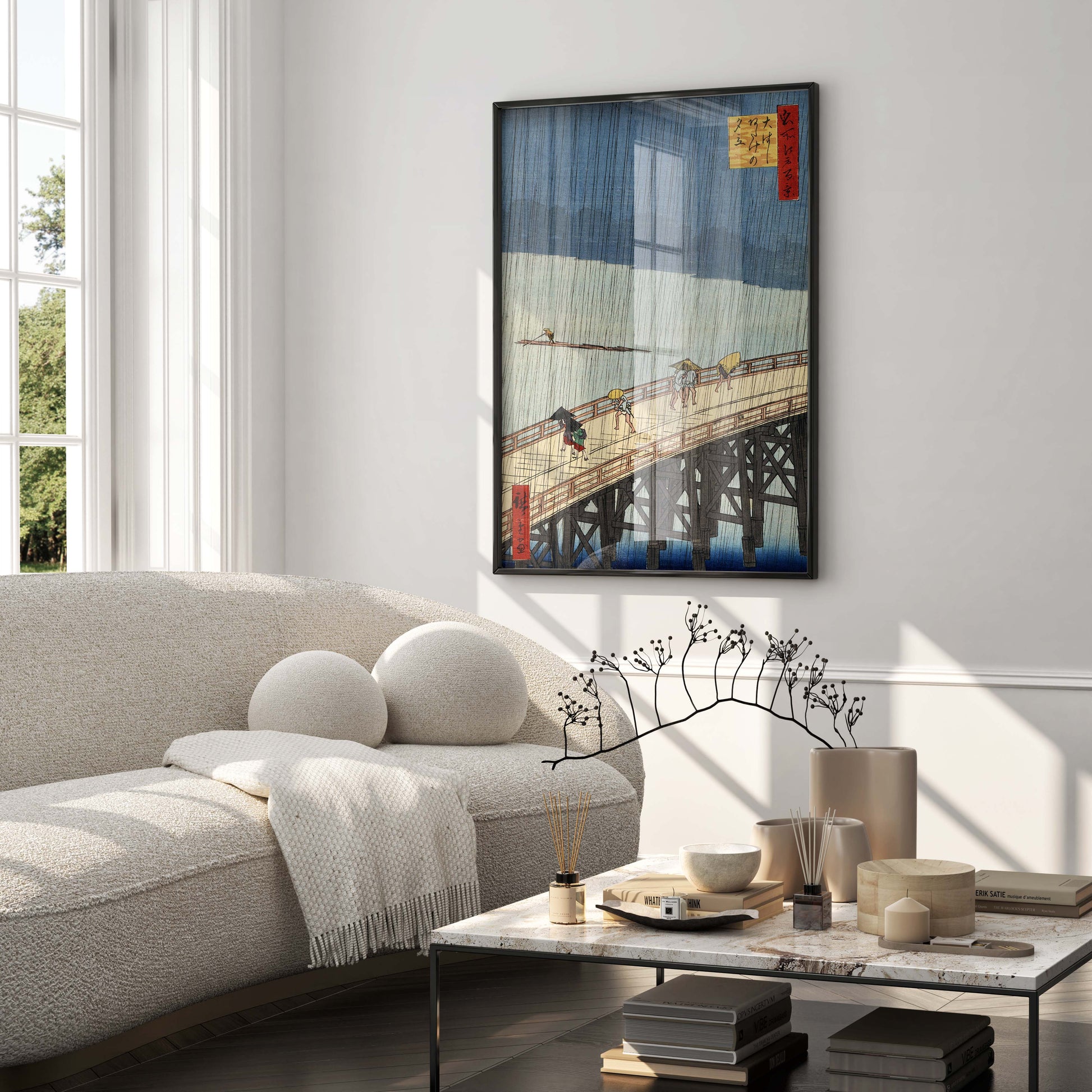 A large, elegant framed Japanese woodblock print by Hiroshige serving as the main wall decor in a modern, minimalist luxury living room.