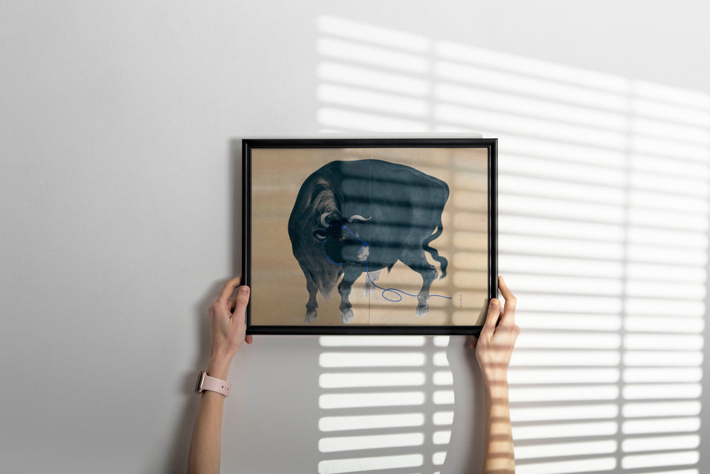 Elegant framed reproduction of Japanese bull painting by Gyokusen hung as sophisticated wall art, perfect example of Asian cultural home decor display