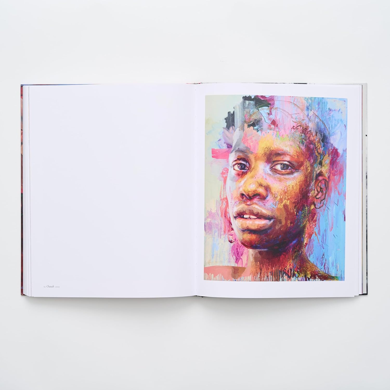 A page from the Jenny Saville art book showing a single full-page image of the painting 'Rapture'. The portrait is an intense, colourful depiction of a human face with textured brushwork. The title and date are visible in the bottom corner of the opposing page.