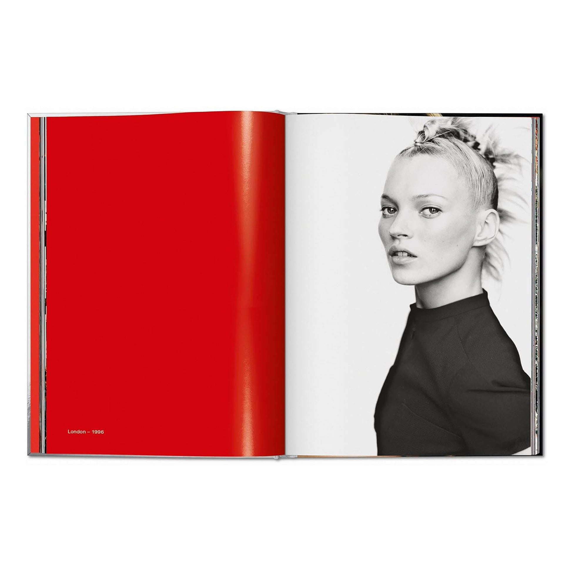 A double-page spread. The left page is solid red. The right page shows a black and white portrait of Kate Moss looking over her shoulder, with her hair in a unique style. The caption reads "London - 1996."