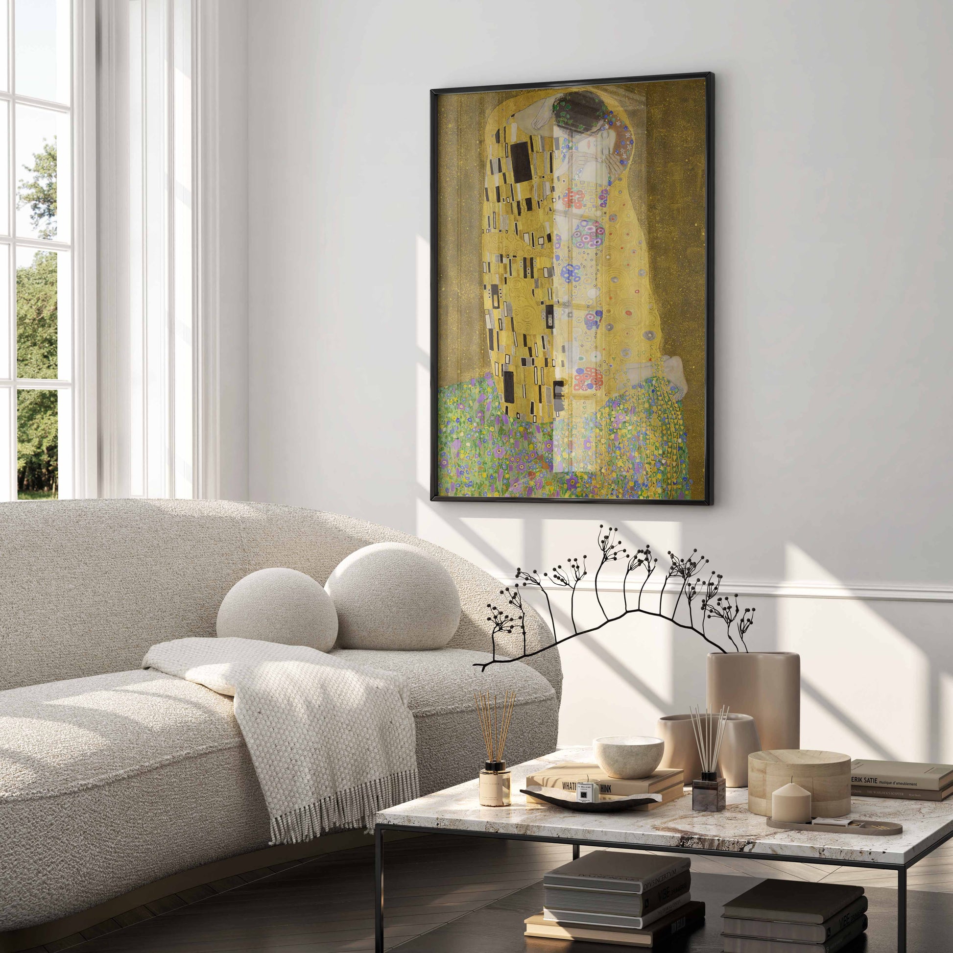 Framed art print of Gustav Klimt’s The Kiss styled in a high-end living room, featuring elegant wall art with rich gold tones and fine detail.