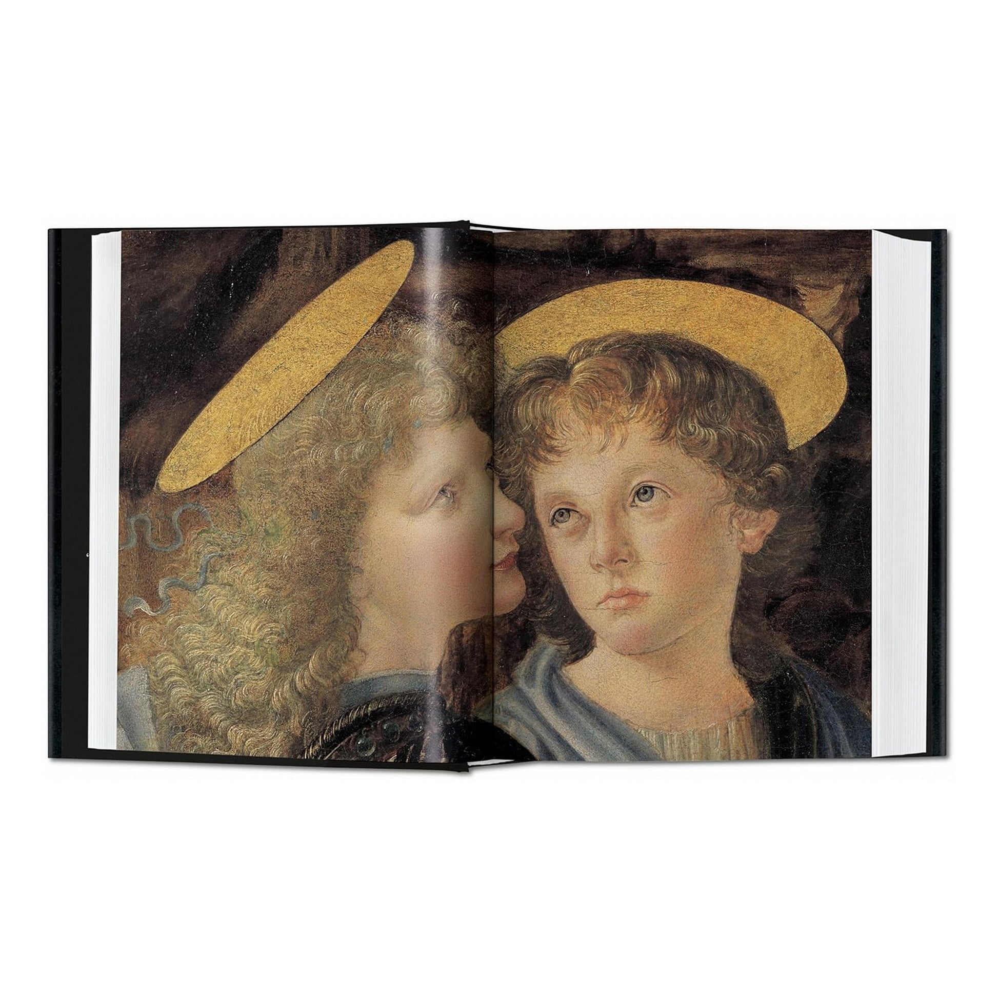 A detailed, crisp reproduction of a painting showing two angelic figures, demonstrating the exceptional printing quality of this Taschen luxury art book on Leonardo da Vinci.