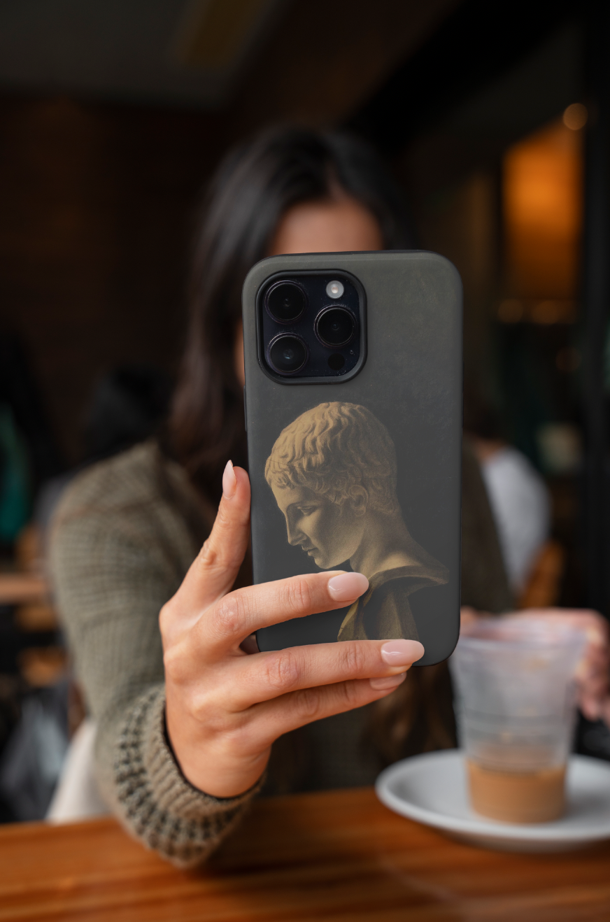 A lifestyle shot of the durable Lili Elbe phone case, highlighting its dual-layer protection. The design pays homage to the pioneering trans artist and her beautiful figurative art.