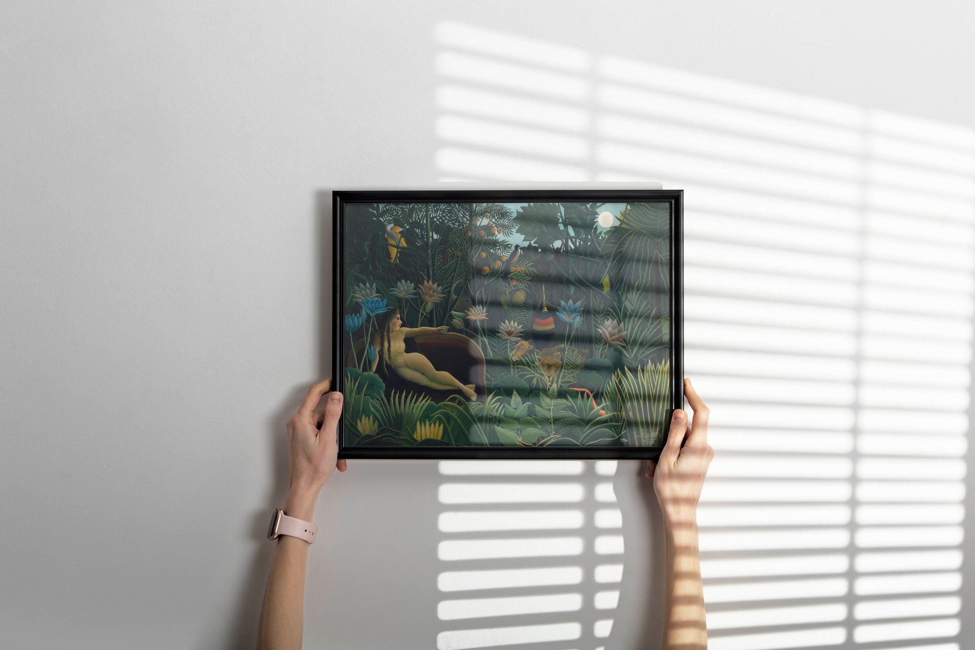 Elegant art print of Henri Rousseau's "Le Rêve" hanging above a sofa in a sophisticated, minimalist living room with natural light.