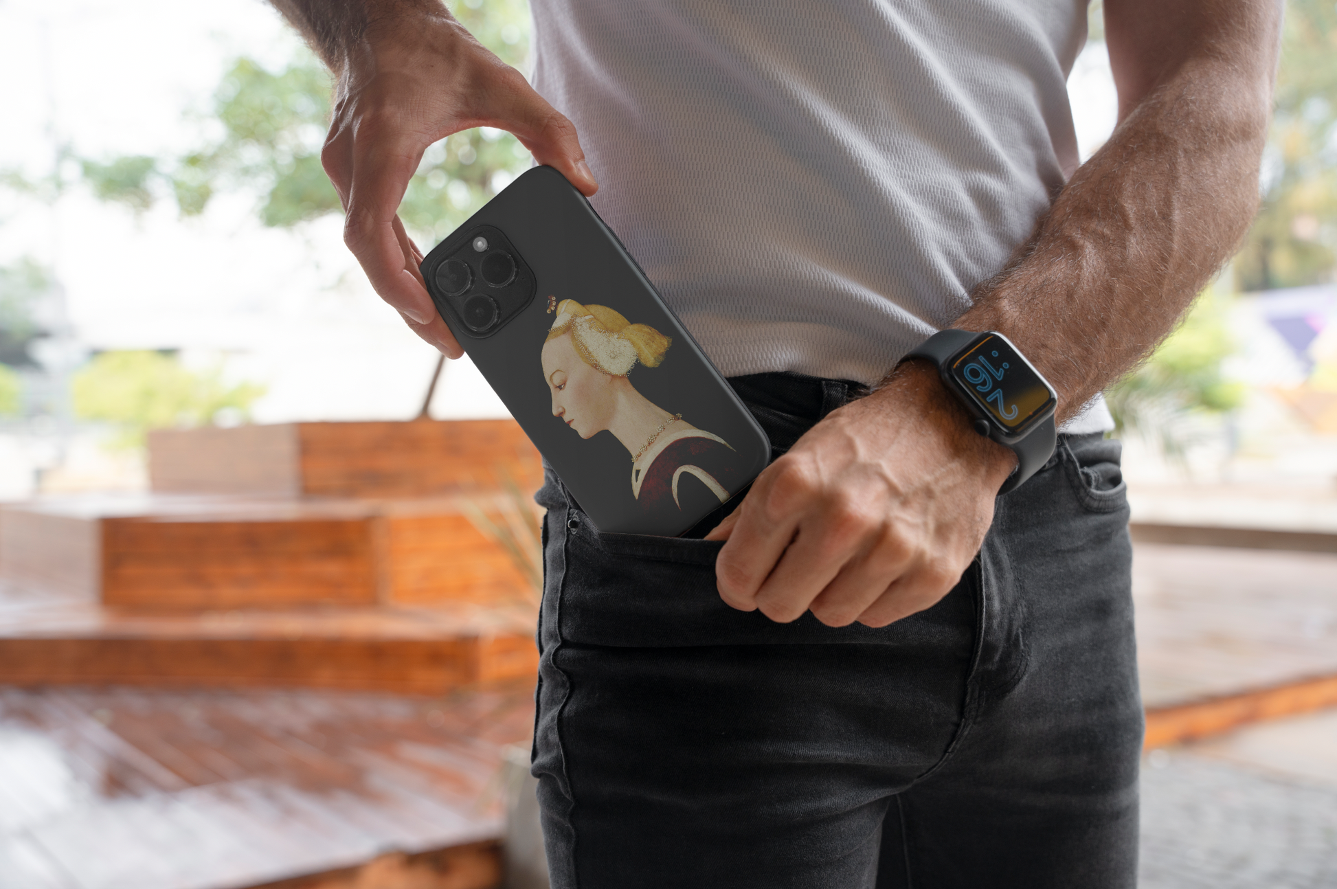 A person is seen putting a phone with the ART SNOB "Master of the Castello Nativity Portrait of a Woman" phone case into their jeans pocket. The focus is on the phone case's fine art print, highlighting its stylish design and the convenience of carrying it.
