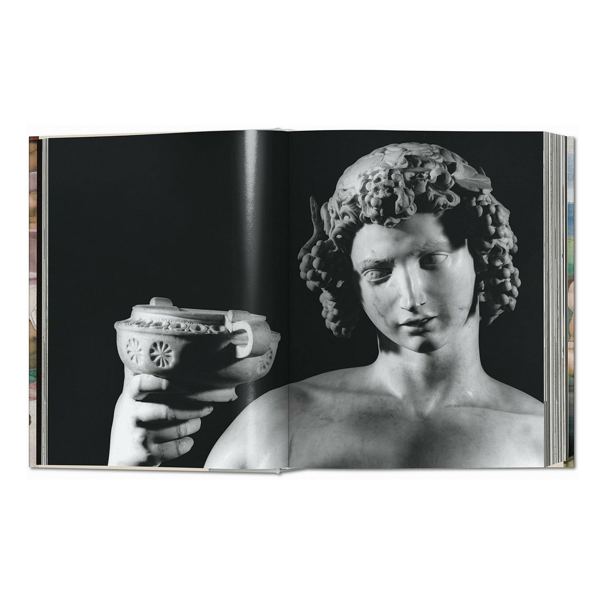 A classic black and white photograph of Michelangelo's early marble sculpture, Bacchus, a significant piece of Italian Renaissance sculpture.
