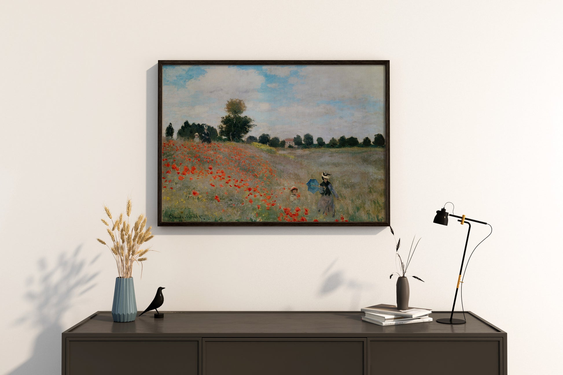 A framed art print of Monet's Poppy Field hanging in a modern living room, highlighting the vibrant colours and museum-quality finish.
