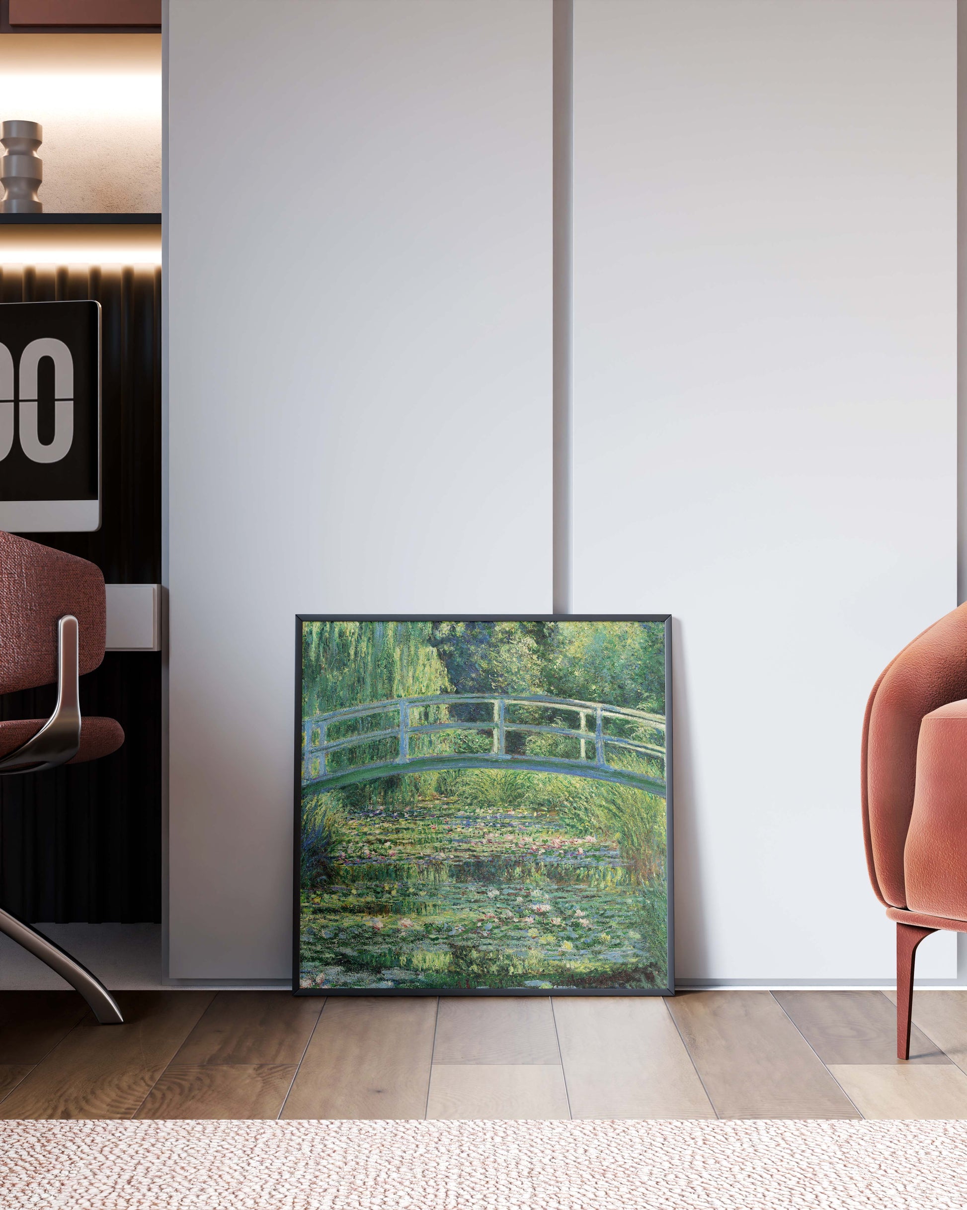 A framed art print of Claude Monet's The Water-Lily Pond leaning against a clean white wall on a wooden floor, providing a stylish accent in a modern interior setting.