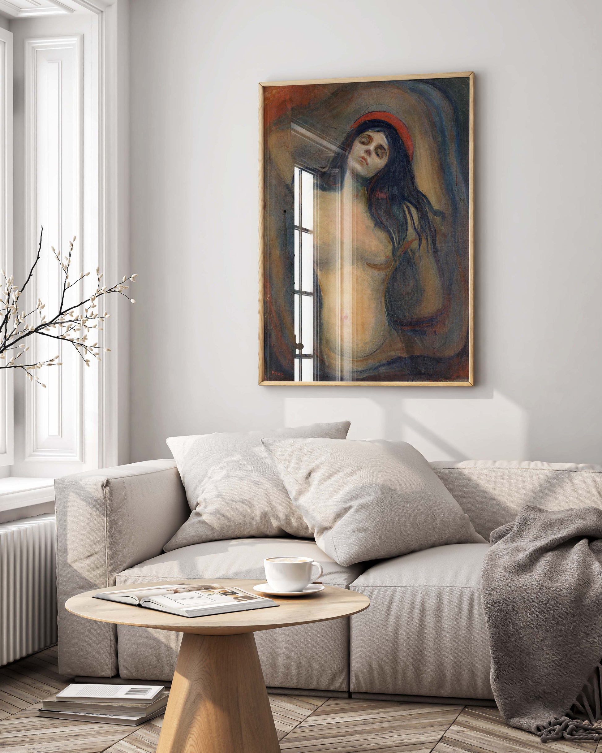 A framed Edvard Munch Madonna art print elegantly displayed as a centrepiece in a modern, luxury living room with high-end furniture