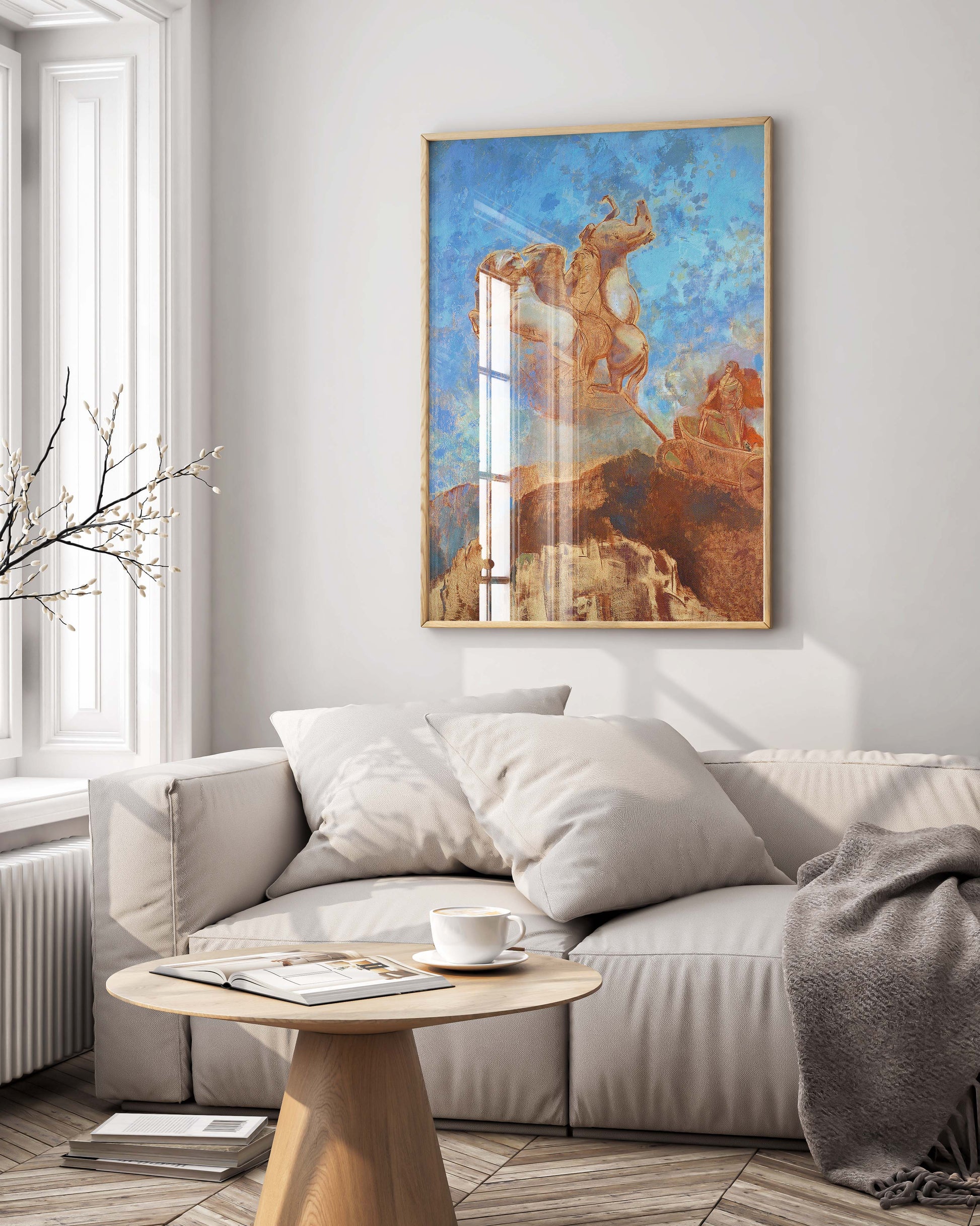Elegant framed reproduction of Redon's Apollo chariot painting hung above sofa in stylish interior, demonstrating premium wall art placement for sophisticated home design and art collection display