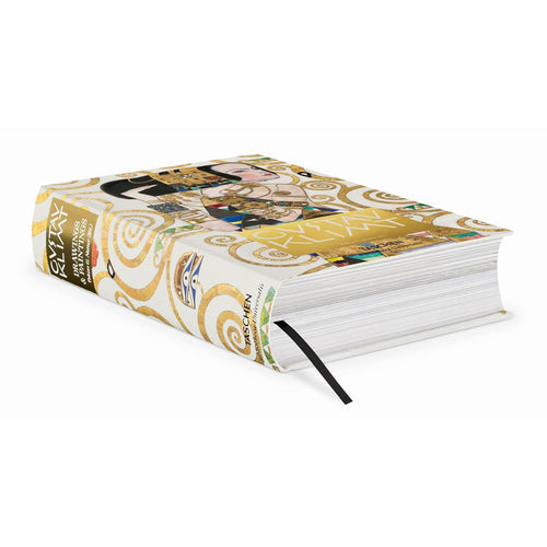 A side view of the Taschen Gustav Klimt luxury art book, showing the thick pages, golden spine, and a black bookmark ribbon. A perfect collector's edition coffee table book.