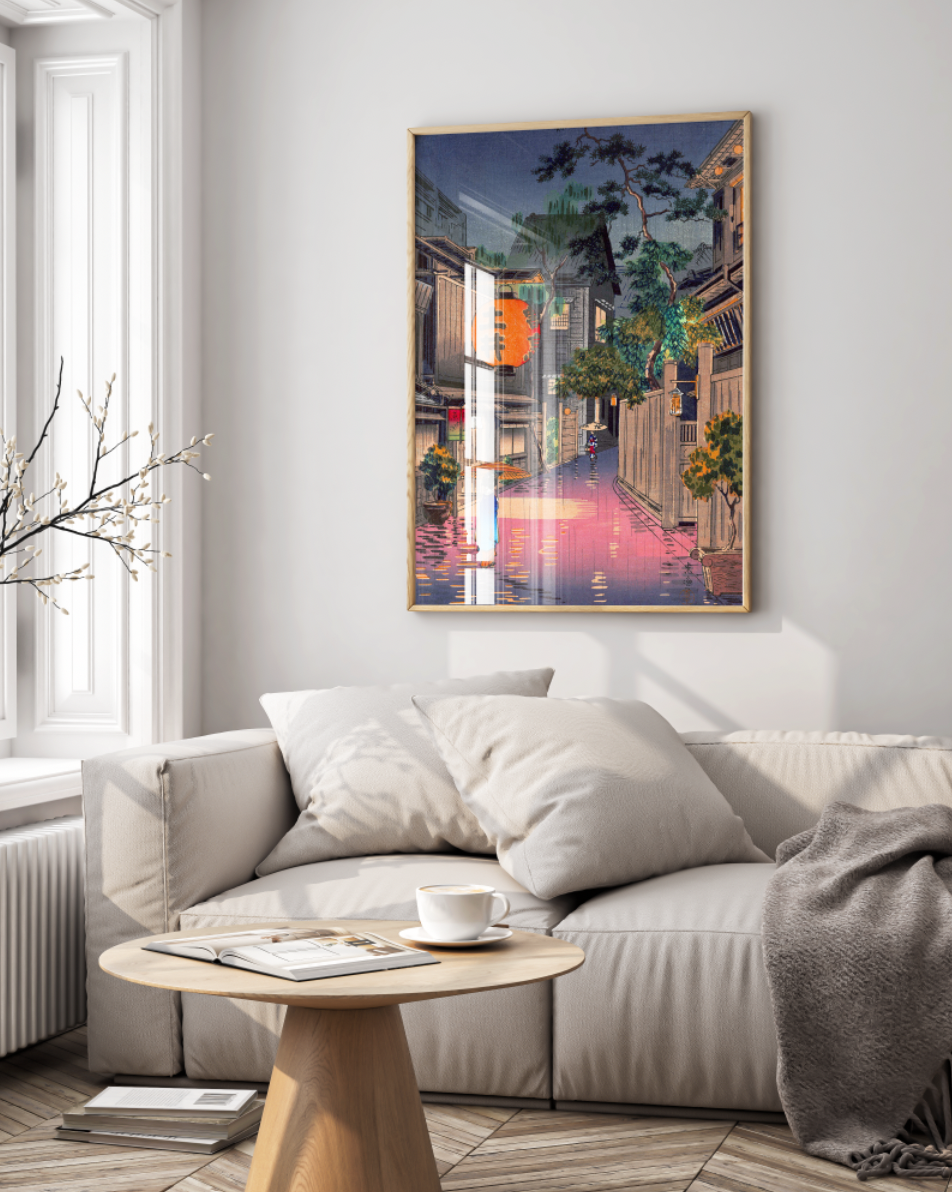 A framed Tsuchiya Koitsu "Evening at Ushigome" Japanese art print hanging as a statement piece above a light-colored sofa in a minimalist living room, showcasing the print as modern home wall art.
