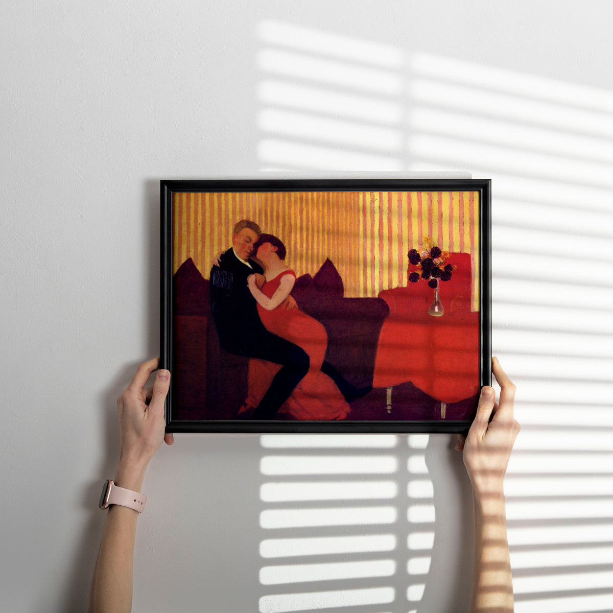 Symbolist-era fine art print in the Nabis style, showing a couple in close embrace surrounded by patterned wallpaper and red furnishings.