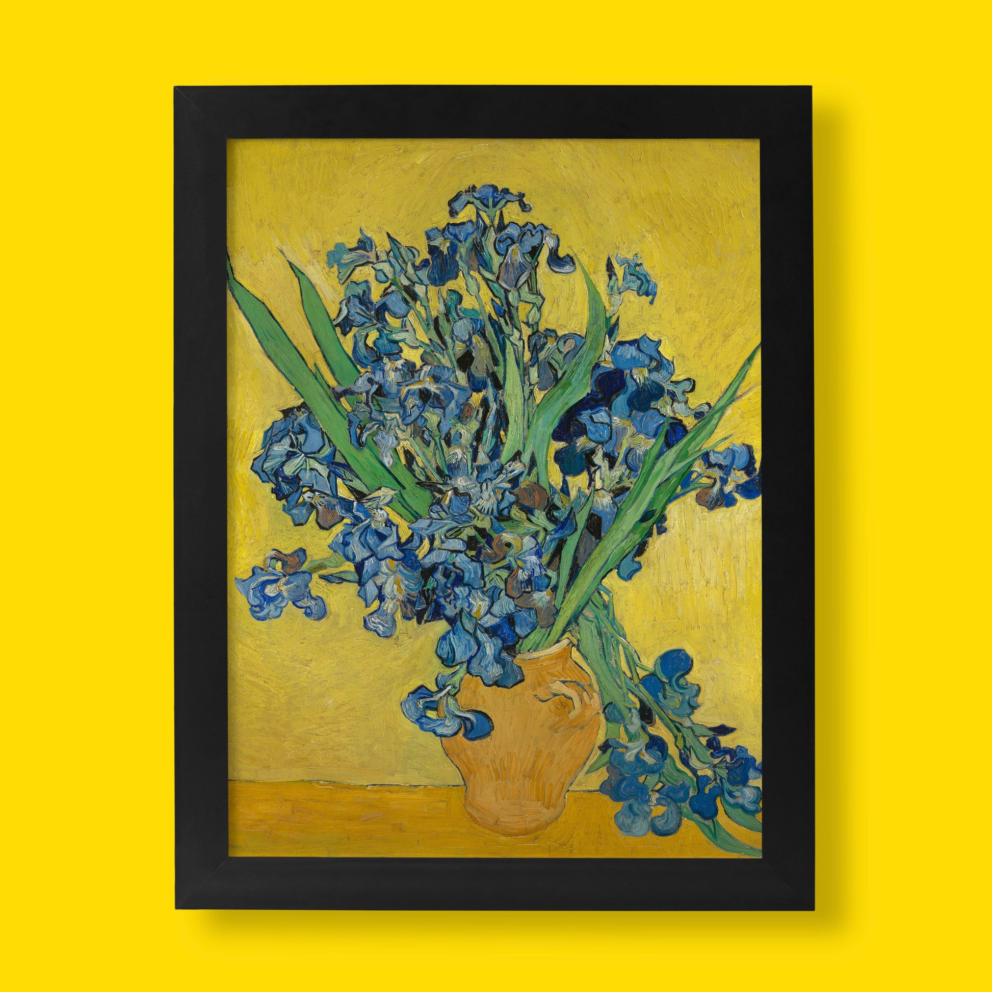 A high-quality giclée fine art print of Vincent van Gogh's painting, "Irises," showing a vase of blue and purple irises against a vibrant yellow background.