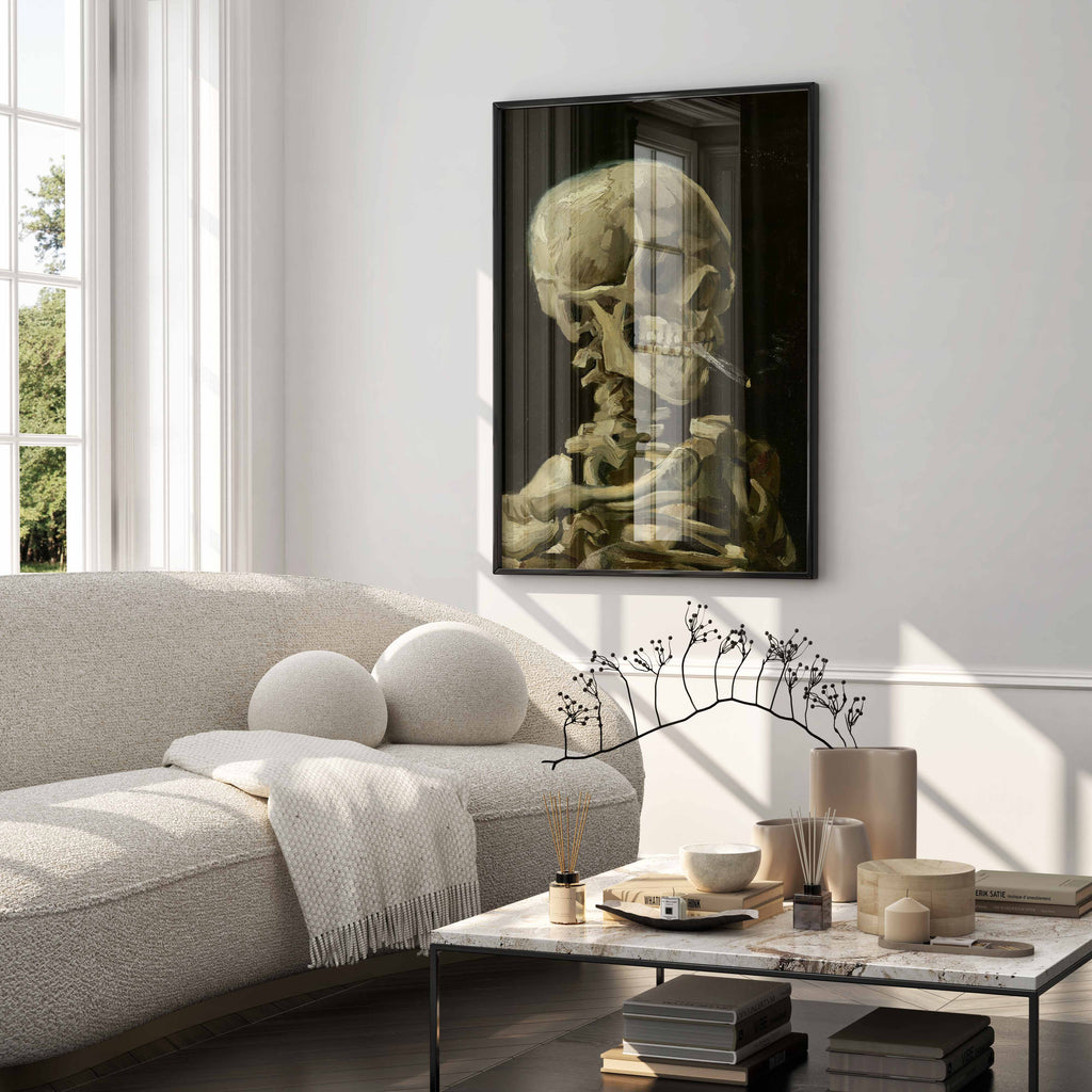 High-quality framed canvas print featuring Vincent van Gogh's iconic 'Head of a Skeleton with a Burning Cigarette,' enhancing the aesthetic of a stylish living room. This fine art print serves as premium wall decor, blending historical art with modern interiors.