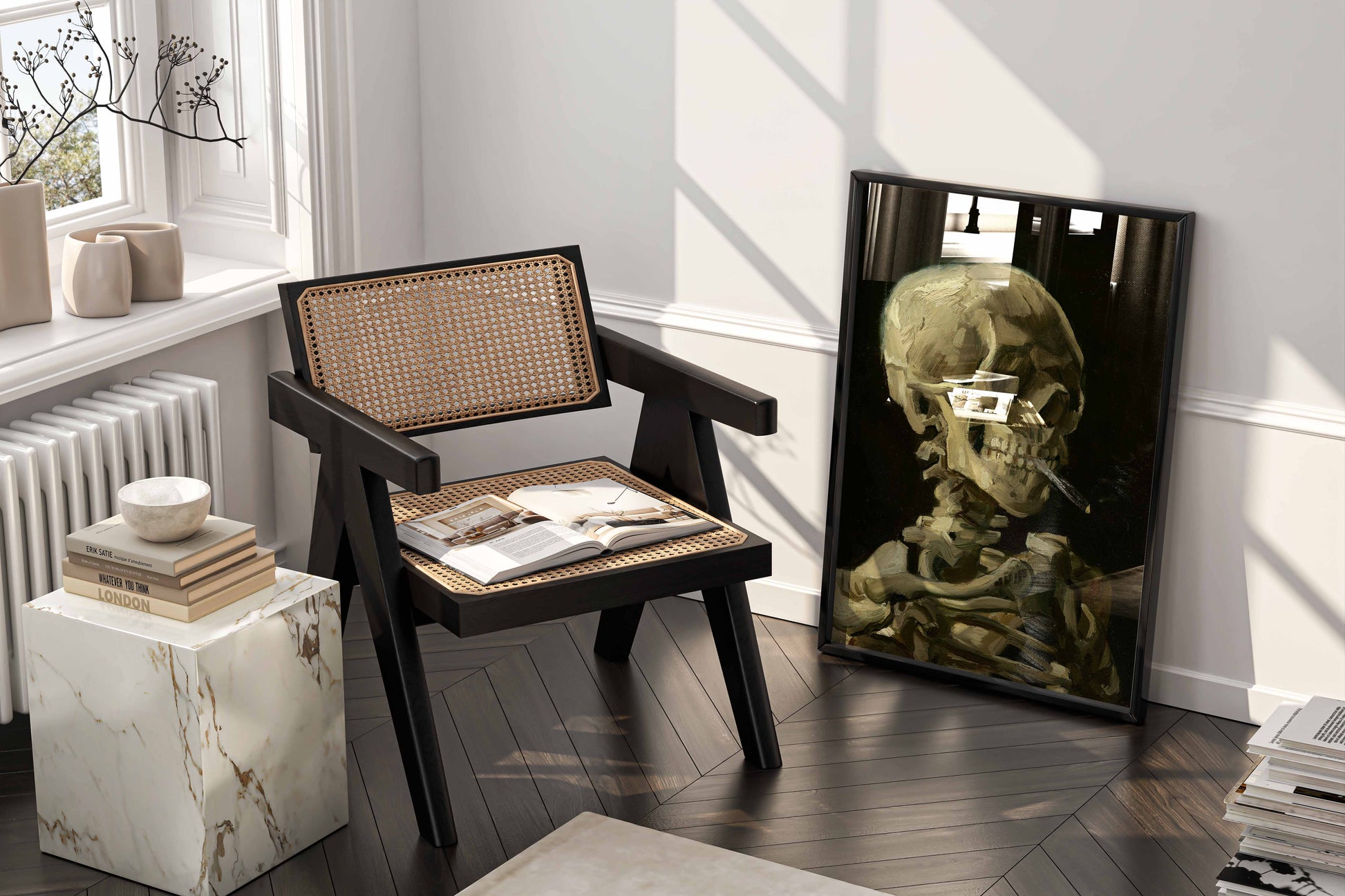 High-quality framed art print featuring Vincent van Gogh's iconic 'Head of a Skeleton with a Burning Cigarette,' displayed casually leaning against a wall in a chic reading nook or bedroom. This fine art print adds depth and artistic flair to any modern living space.