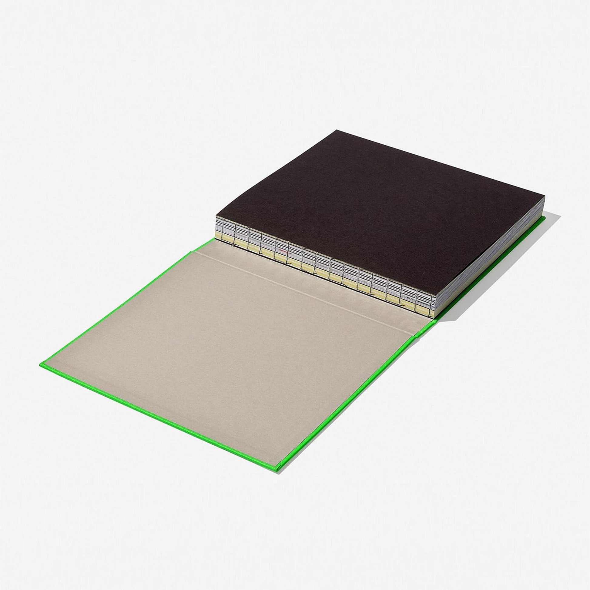 A three-quarter angle of the hardcover art book "Virgil Abloh. Nike. ICONS" by Taschen, highlighting the neon green cover, the spine with the artist's name, and the "luxury fashion book" aesthetic.