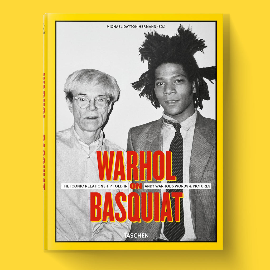 The cover of the luxury hardcover art book "Warhol on Basquiat" by TASCHEN, featuring a black and white photograph of Andy Warhol and Jean-Michel Basquiat.