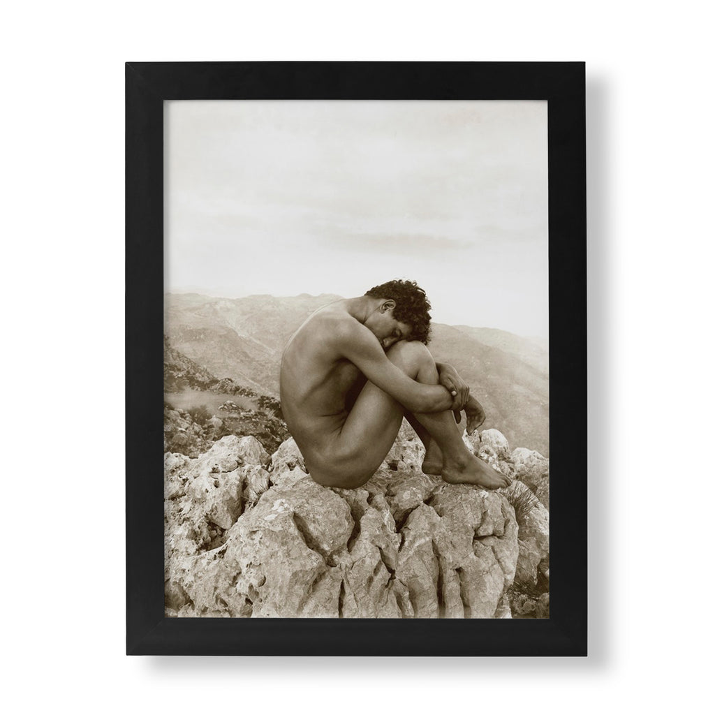 Wilhelm von Gloeden "Cain" photography print, a fine art piece depicting a solitary, curled nude male figure on a rugged rock outcrop, with a sepia-toned landscape background.