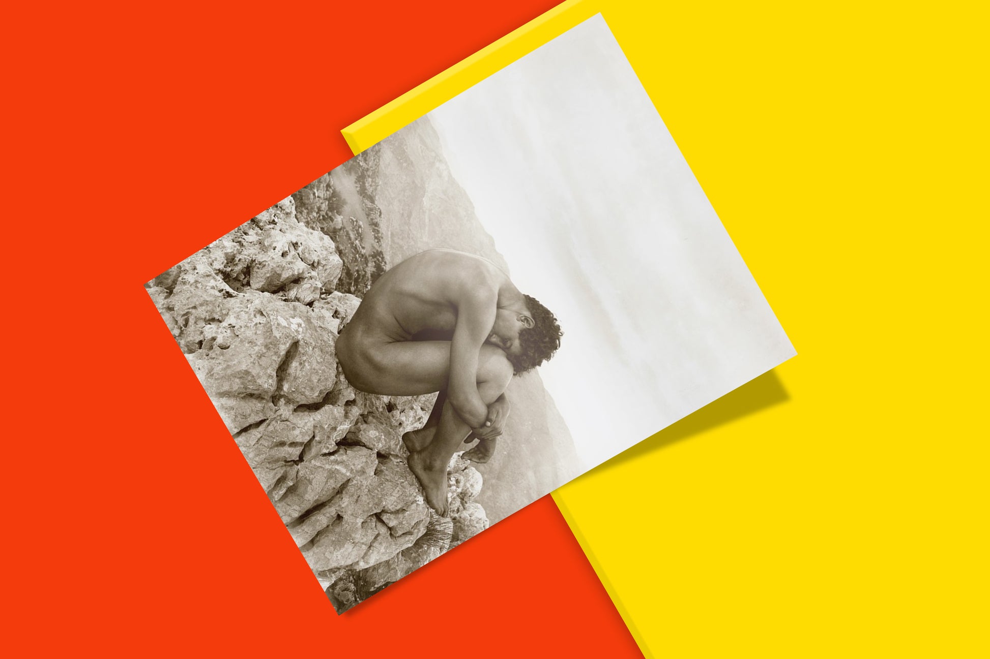 A fine art photography print of "Cain" by Wilhelm von Gloeden, perfect for wall art, showing a nude male figure seated on rocks, a profound image of biblical remorse and personal myth.