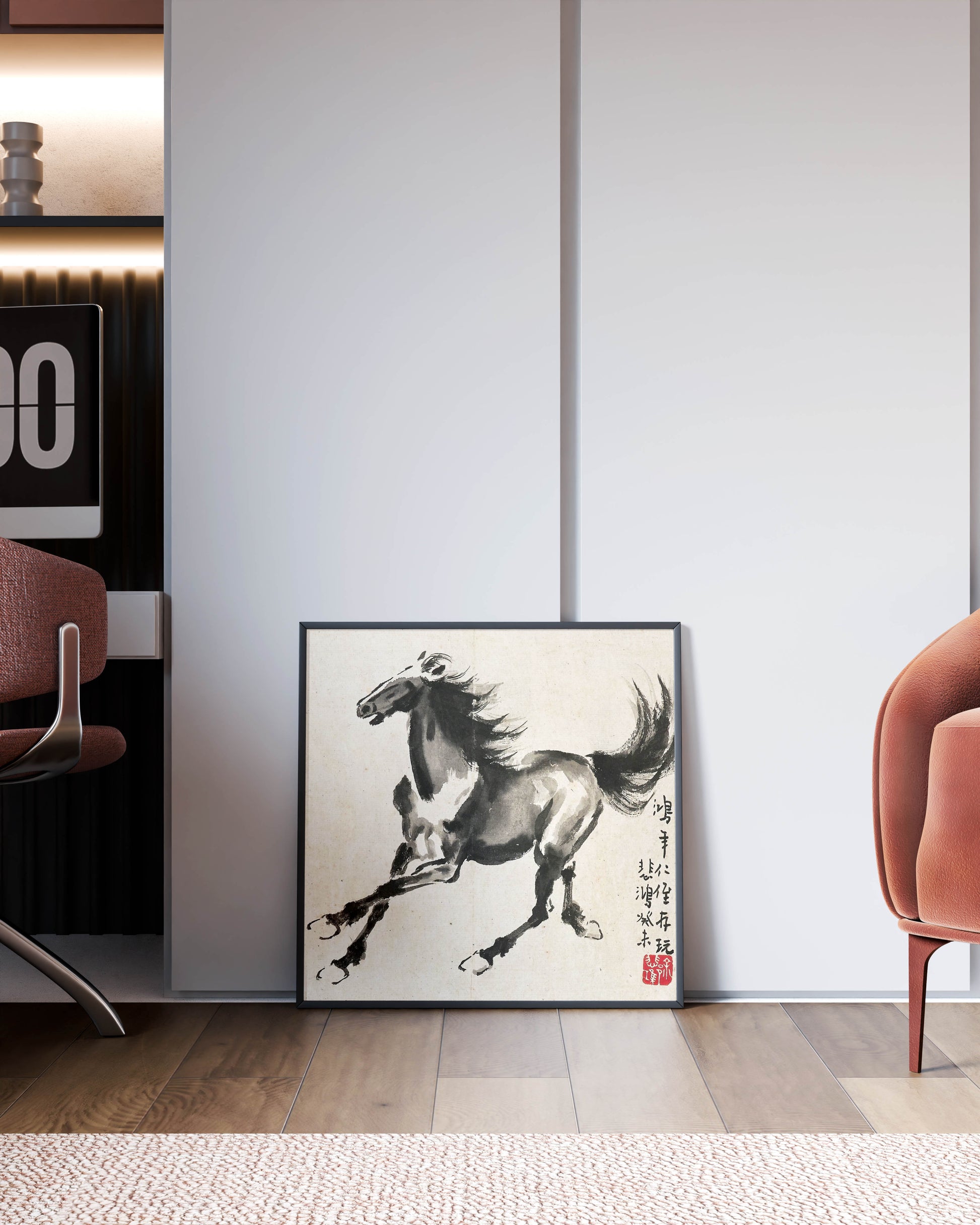 A framed Xu Beihong "Running Horse" art print leaning against a minimalist white wall, with a blush pink armchair and a desk in the background, showcasing how the fine art wall art fits into modern home décor.