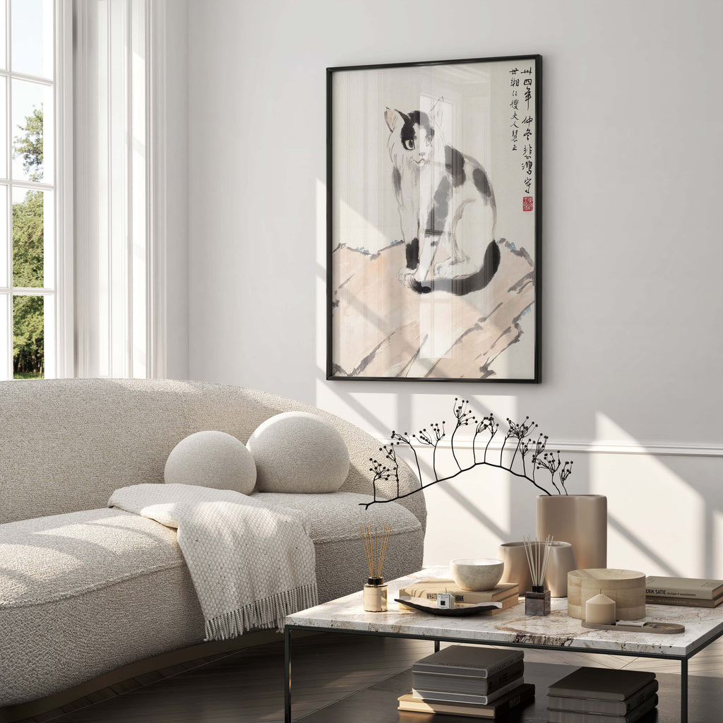 A framed fine art print of Xu Beihong's cat painting displayed in a modern, minimalist living room, showcasing how the wall art enhances home decor.